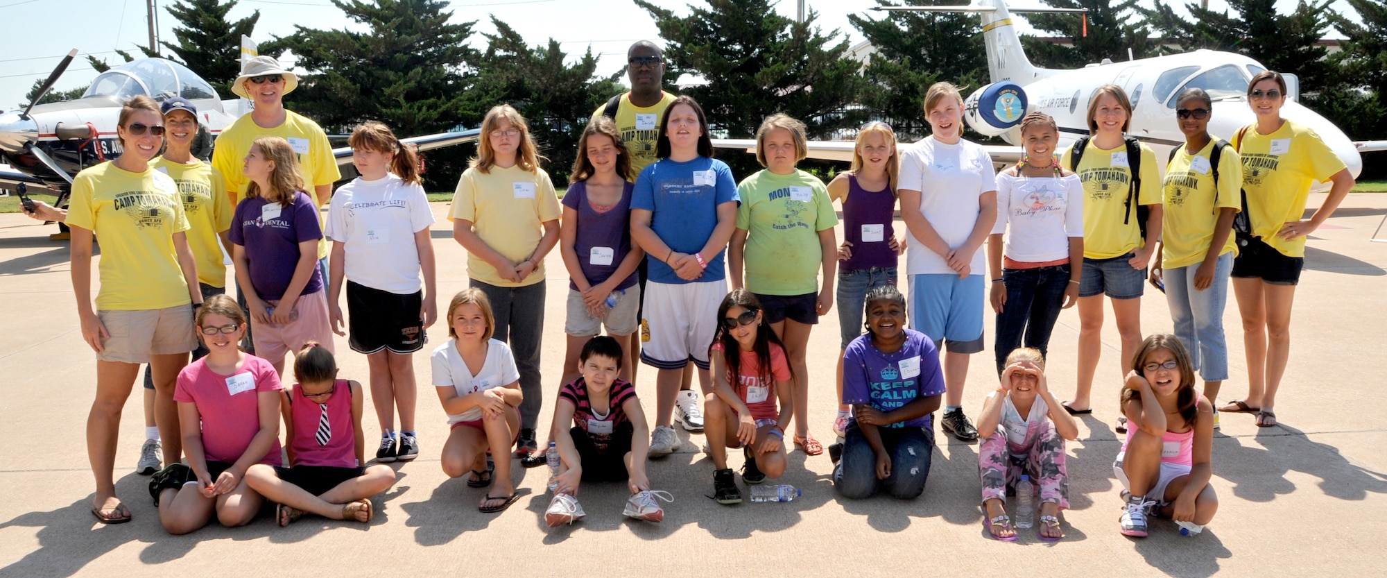 Campers and volunteers from Vance Air Force Base, Okla., gather for a group photo outside Hangar 141 during the 38th Camp Tomahawk, a free summer camp for the boy and girls of Enid, Okla. (U.S. Air Force photo/ Airman 1st Class Frank Casciotta)
