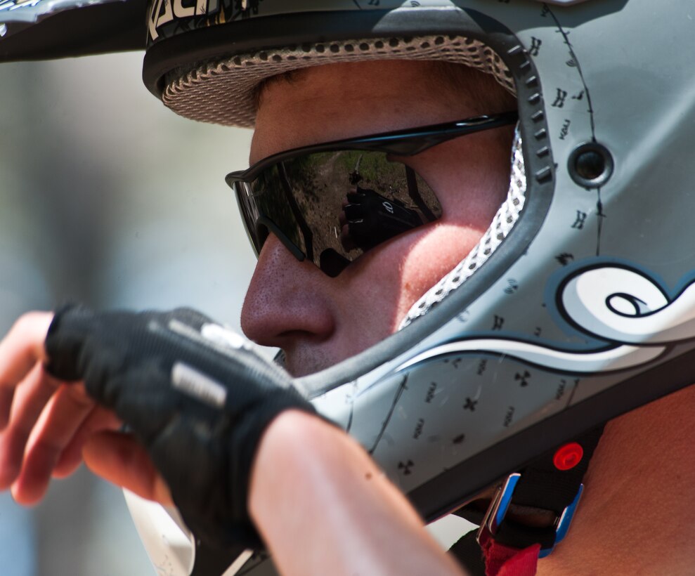 Airman 1st Class Brody Schneider, 28th Operations Support Squadron air traffic control technician, wipes sweat from his brow after successfully maneuvering down a mountain bike trail at Storm Mountain, S.D., June 24, 2012. During this high intensity sport, Schneider and his fellow riders took drink breaks every 20 to 30 minutes to ensure they remained hydrated throughout the day. (U.S. Air Force photo by Airman 1st Class Alystria Maurer/Released)