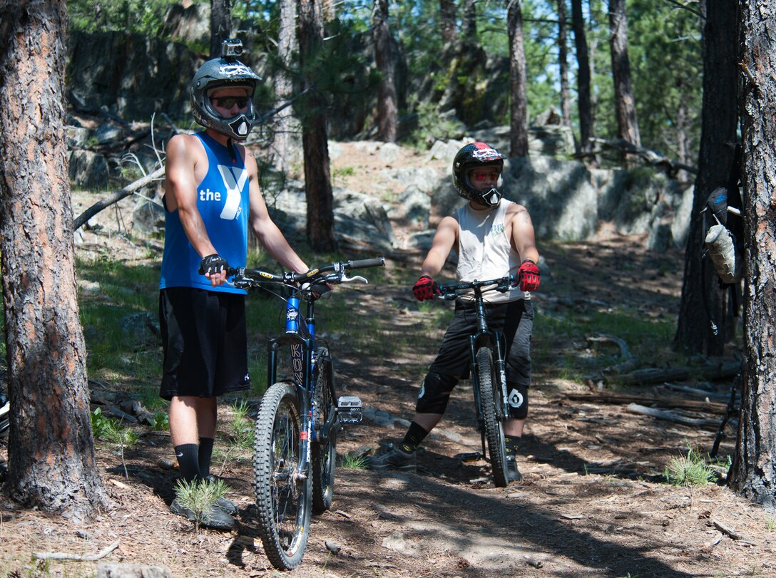 Airman 1st Class Brody Schneider, (left) and Senior Airman Justin Faircloth, 28th Operations Support Squadron air traffic control technicians, assess a mountain biking trail at Storm Mountain, S.D., June 24, 2012. All Airmen are encouraged to make safety and risk management part of all of their outdoor activities. (U.S. Air Force photo by Airman 1st Class Alystria Maurer/Released)
