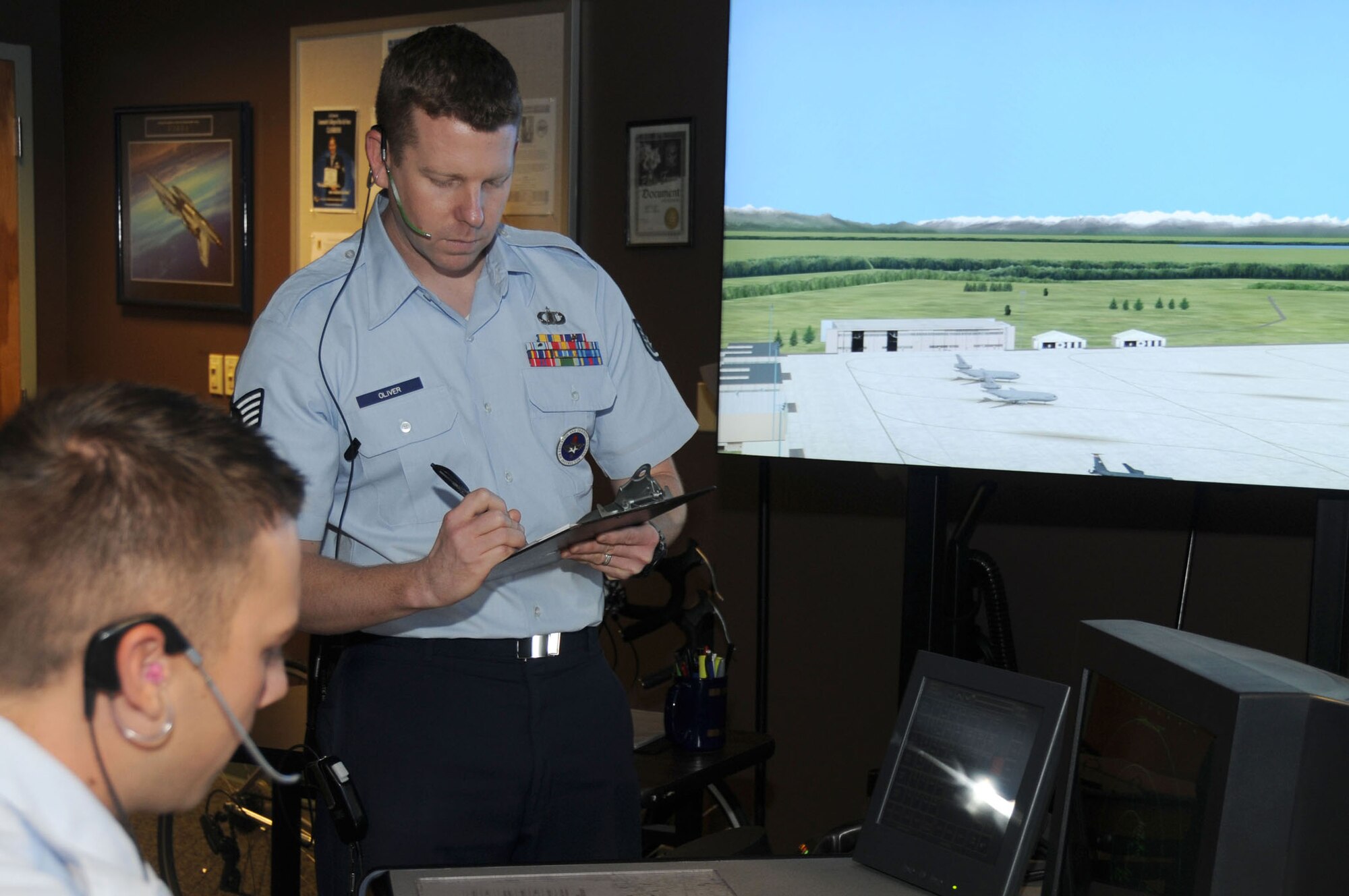 Staff Sgt. Thomas Oliver, 334th Training Squadron air traffic control instructor, evaluates his students’ progress during class June 18, 2012, at Cody Hall, Keesler Air Force Base, Miss.  Oliver was selected into the nurse enlisted commissioning program June 13. (U.S. Air Force photo by Kemberly Groue)