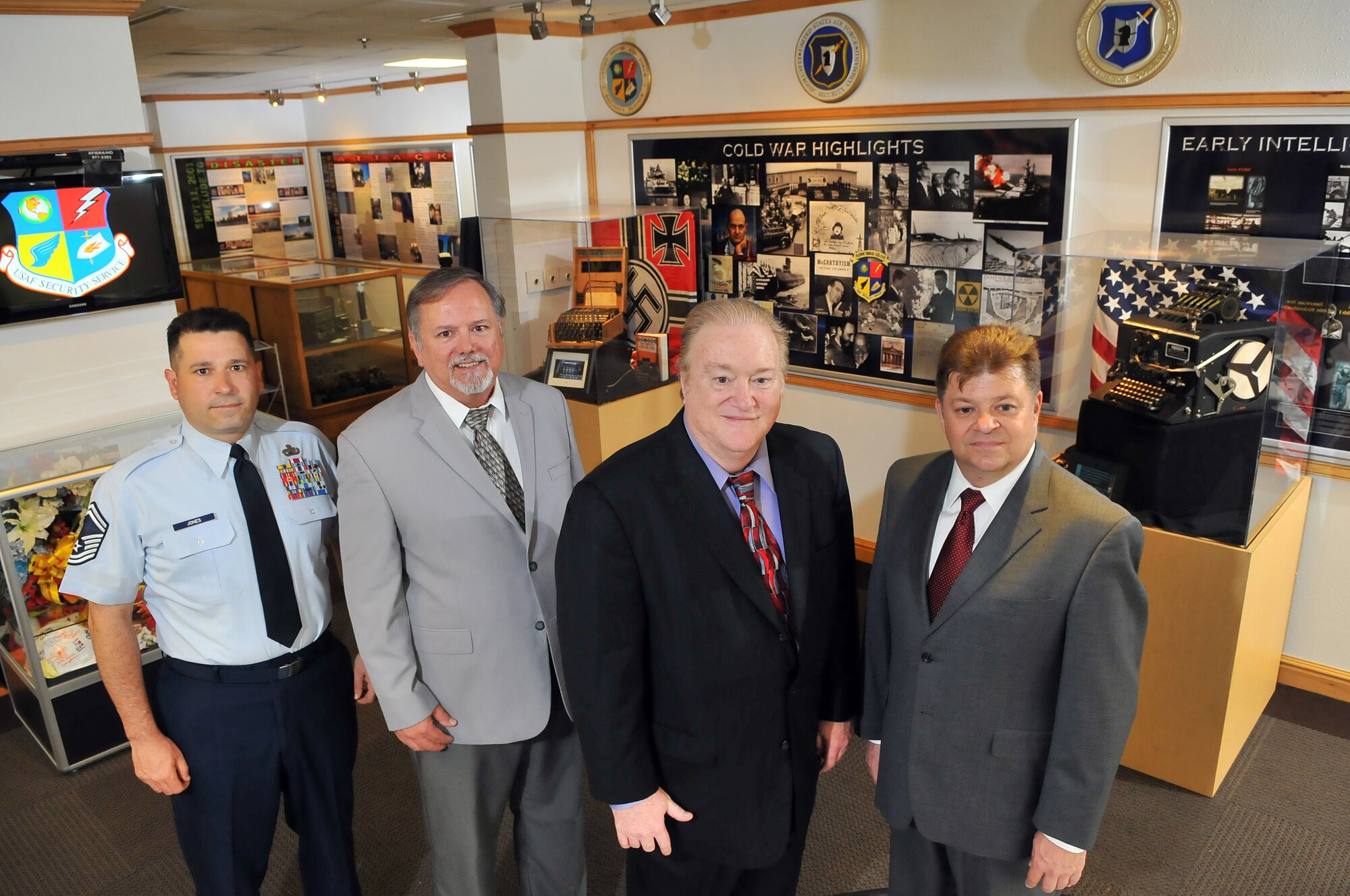 LACKLAND AIR FORCE BASE, Texas -- The Air Force Intelligence, Surveillance and Reconnaissance Agency History Office team (left to right), Senior Master Sgt. Benjamin Jones, John Williamson, Chief Historian Phil Myers and Gabe Marshall, pose in the agency's Dr. Dennis F. Casey Heritage Center. The foursome are repeat winners of the Brig. Gen. Brian S. Gunderson Excellence in History Programs Award and the Air Force Heritage Award. (U. S. Air Force photo by William Belcher)    