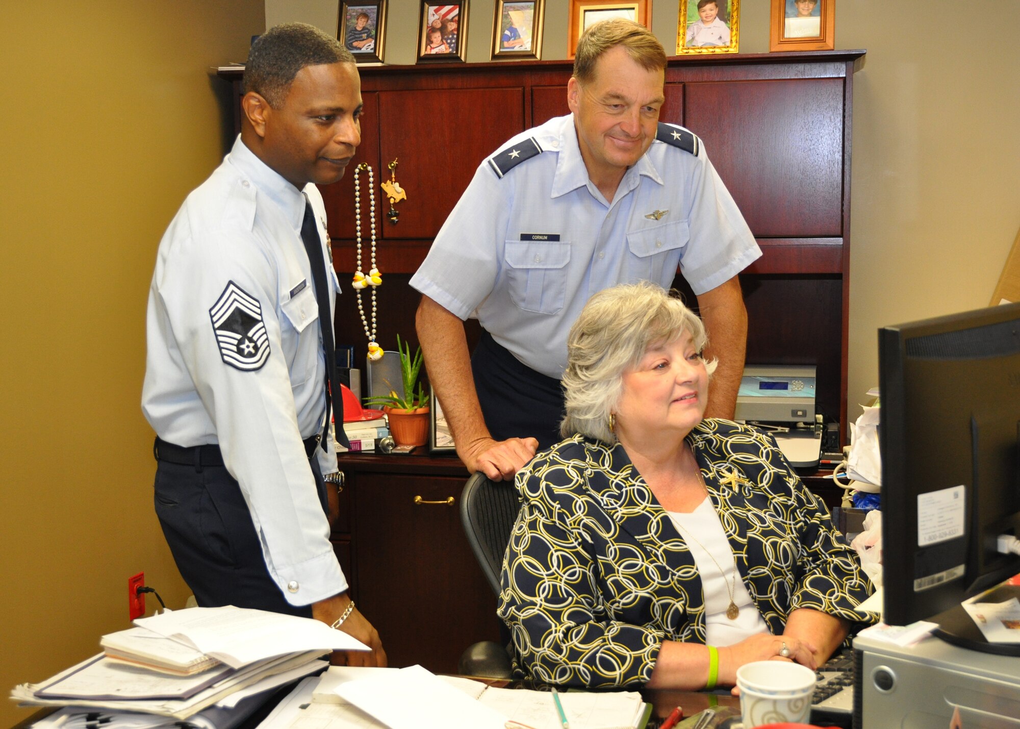 Chief Master Sgt. Michael Anderson, 81st Medical Group superintendent, reviews the commander’s schedule with Brig. Gen. (Dr.) Kory Cornum, 81st MDG commander, and Kay Hymel, executive assistant to the commander June 3, 2012, at the Keesler Hospital, Keesler Air Force Base, Miss.  (U.S. Air Force photo by Steve Pivnick)