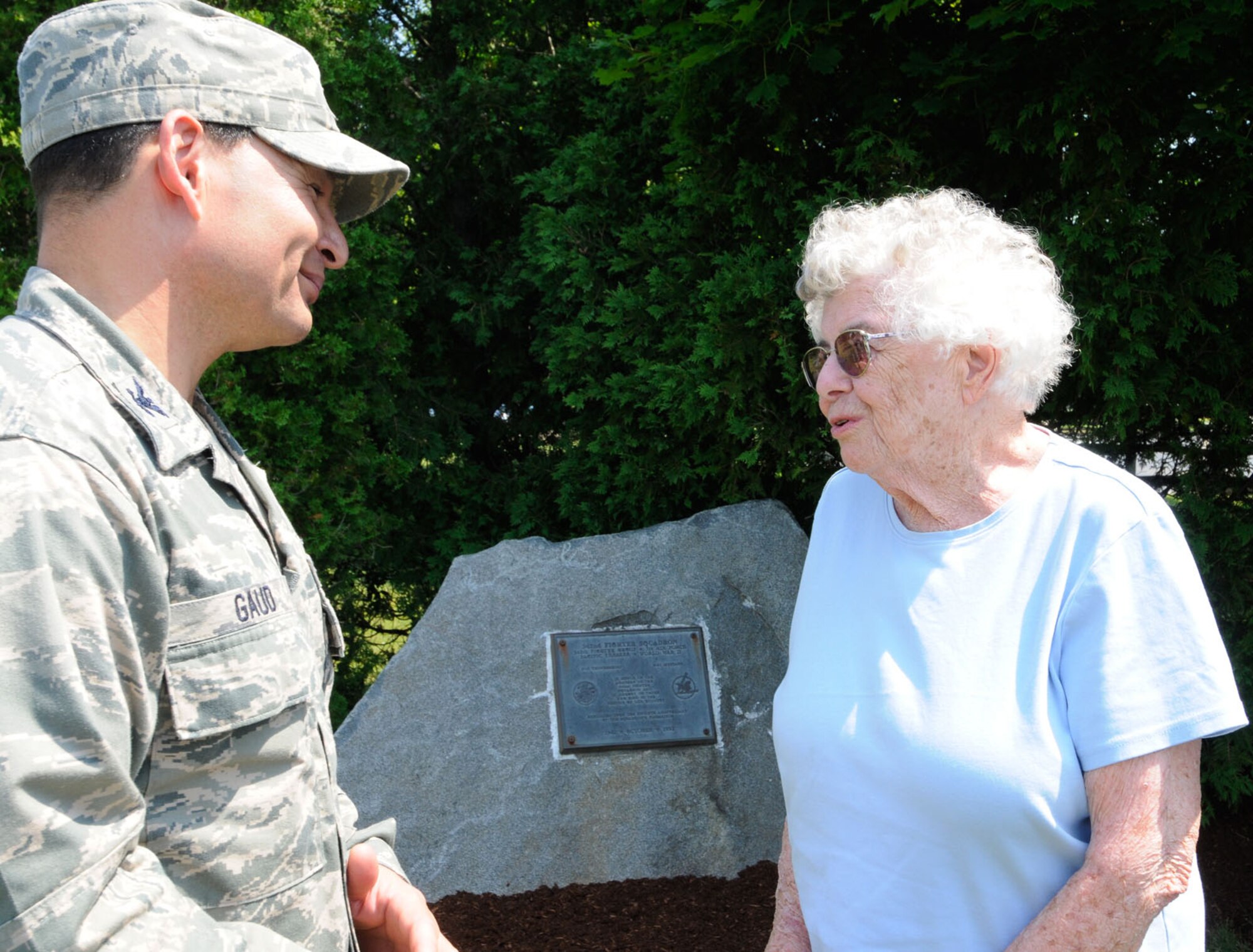 HANSCOM AIR FORCE BASE, Mass. – Col. Juan Gaud, 66th Air Base Group deputy commander, meets with Jane Sutcliffe in front of the 342nd Fighter Squadron plaque in Memorial Park June 22. Sutcliffe, along with six immediate family members, visited the memorial in honor of her late husband Robert, a World War II ace who served with the squadron that was stationed at Hanscom from January to April 1943. (U.S. Air Force photo by Linda LaBonte Britt) 