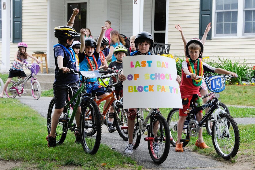HANSCOM AIR FORCE BASE, Mass. – Students cheer before taking off for the bike and scooter parade around base housing during the Last Day of School Block Party June 19. More than 75 parents and children gathered at the corner of Ent and Heritage roads to celebrate summer break courtesy of the Weissman family. (U.S. Air Force photo by Linda LaBonte Britt)