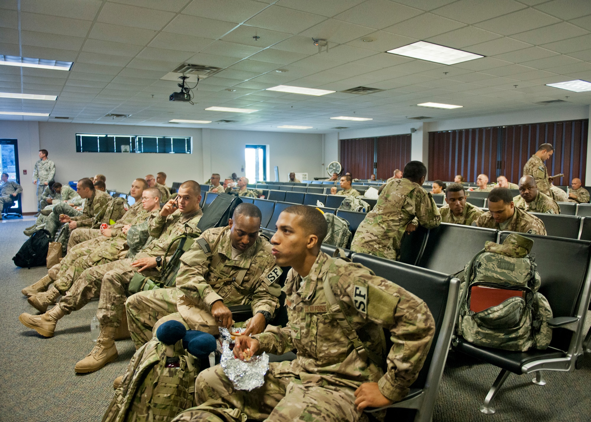 Airmen from Moody and several other bases relax at the deployment control center before leaving for a six-month deployment to Afghanistan, June 26, 2012, at Moody Air Force Base, Ga. The DCC was the Airmen’s final out-processing location before leaving the country. (U.S. Air Force photo by Senior Airman Eileen Meier/Released)