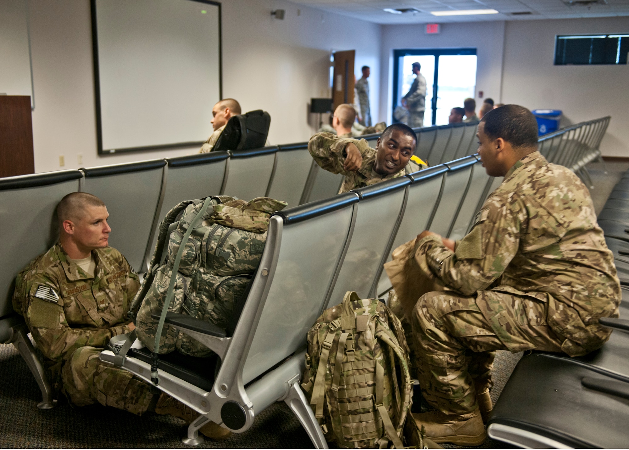 Airmen from various bases wait for their flight to Afghanistan for a six-month deployment, June 26, 2012, at Moody Air Force Base, Ga. Chief Master Sgt. Dianna Vallely, 23d Medical Group chief enlisted manager, and Patricia Wittenborn, 23d Force Support Squadron Airman and Family Readiness Center unit liaison, prepared hot dogs and snacks for their flight overseas. (U.S. Air Force photo by Senior Airman Eileen Meier/Released)