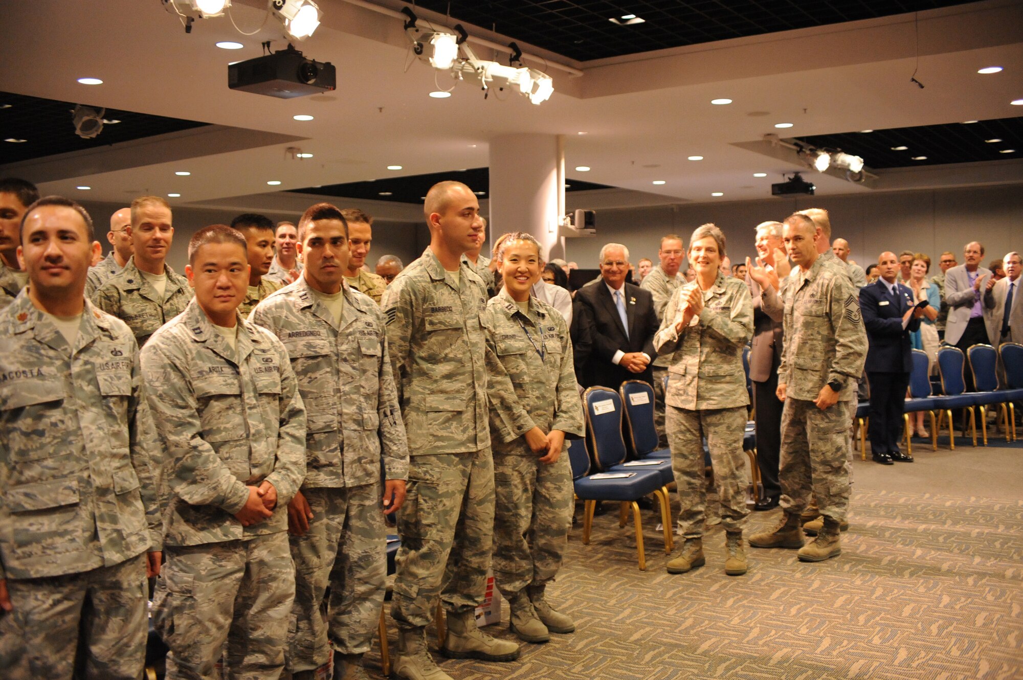 Lieutenant Gen. Ellen Pawlikowski, Space and Missile Systems Center commander, and Chief Master Sgt. Jonathan Rossetti, 61st Medical Squadron superintendent, lead more than 30 honorees in a Welcome Home Airmen Celebration held here, June 26.  The honorees, who returned from recent deployments in various places around the world, were joined by their supervisors, coworkers, friends and families. During the celebration, Lt. Gen. Pawlikowski thanked the troops for what they do every day. She also thanked their friends and neighbors who assisted with family needs while the airman was deployed. (Photo by Sarah Corrice)