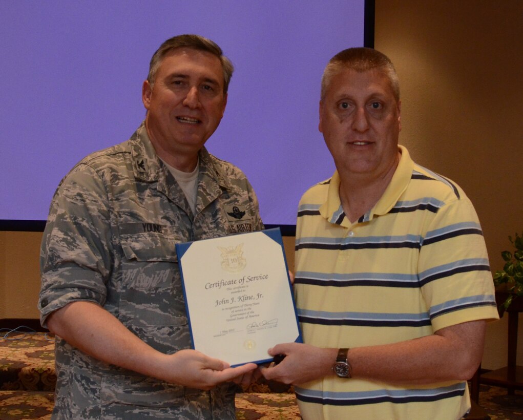 John J. Kline recieves the 30 year service award from Colonel Darrell G. Young  934th Airlift Wing commander, during civilian commanders call at the Services club, Minneapolis-St. Paul Air Reserve Station, Minn. (U.S. Air Force photo by Tech. Sgt. Bob Sommer)