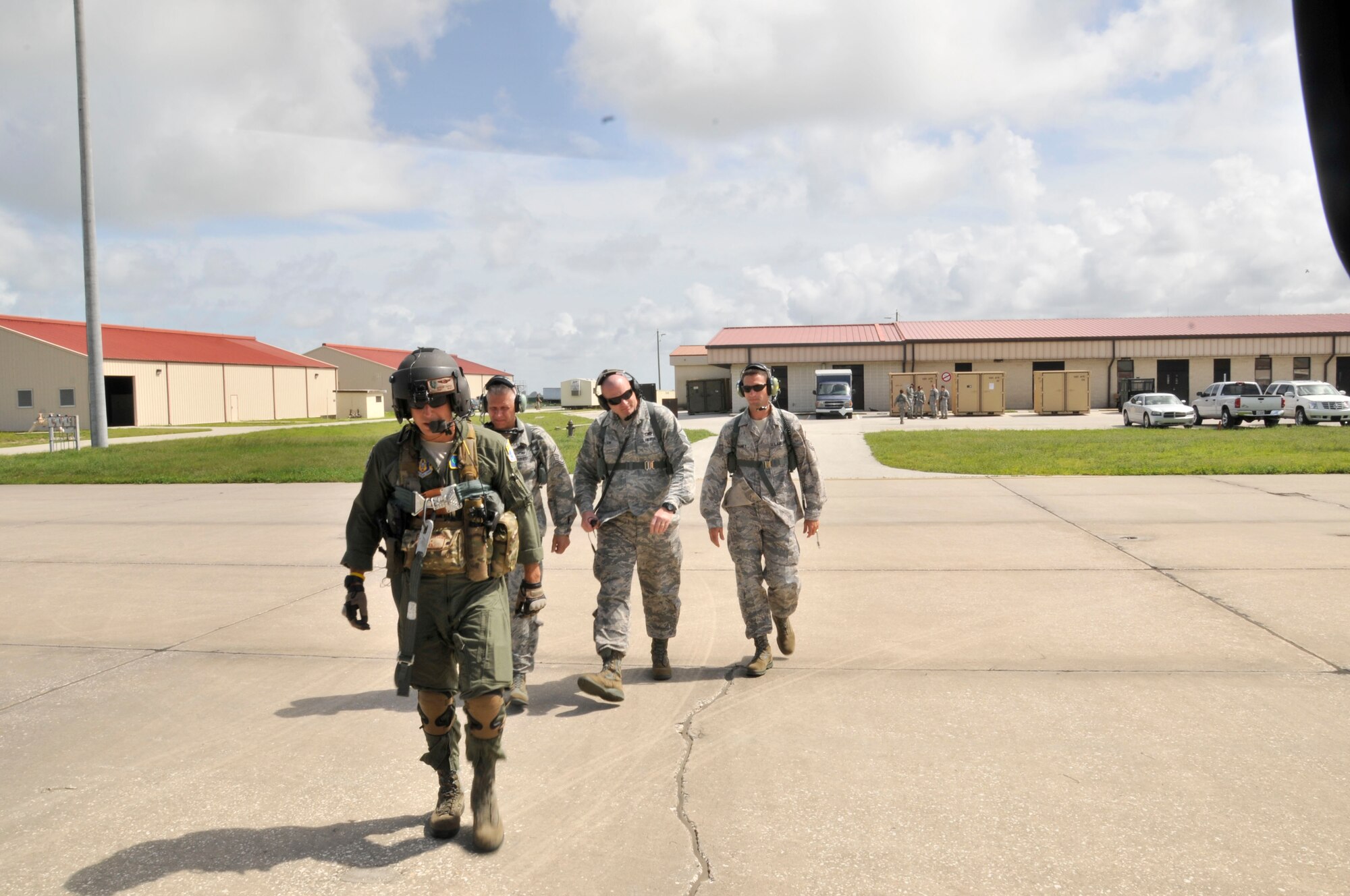 PATRICK AIR FORCR BASE, fla.--Staff Sgt. Adrian Jarrin, 301st Rescue Squadron, gunner, led (from left) Master Sgts. Tommy Vitone, Eric Tolson and Jason Maney, all recruiters to an awaiting HH-60G Pave Hawk helicopter. The recruiters already in town for further educational development participated in a local training flight. The three along with five other recruiters from different locations along the East Coast were rewarded with a birds-eye view of Cape Canaveral Air Force Station, fla., for being top in their area of expertise. All participating recruiters exceeded recruitment goals in their specific target area. (U.S. Air Force photo/TSgt. Peter Dean)  