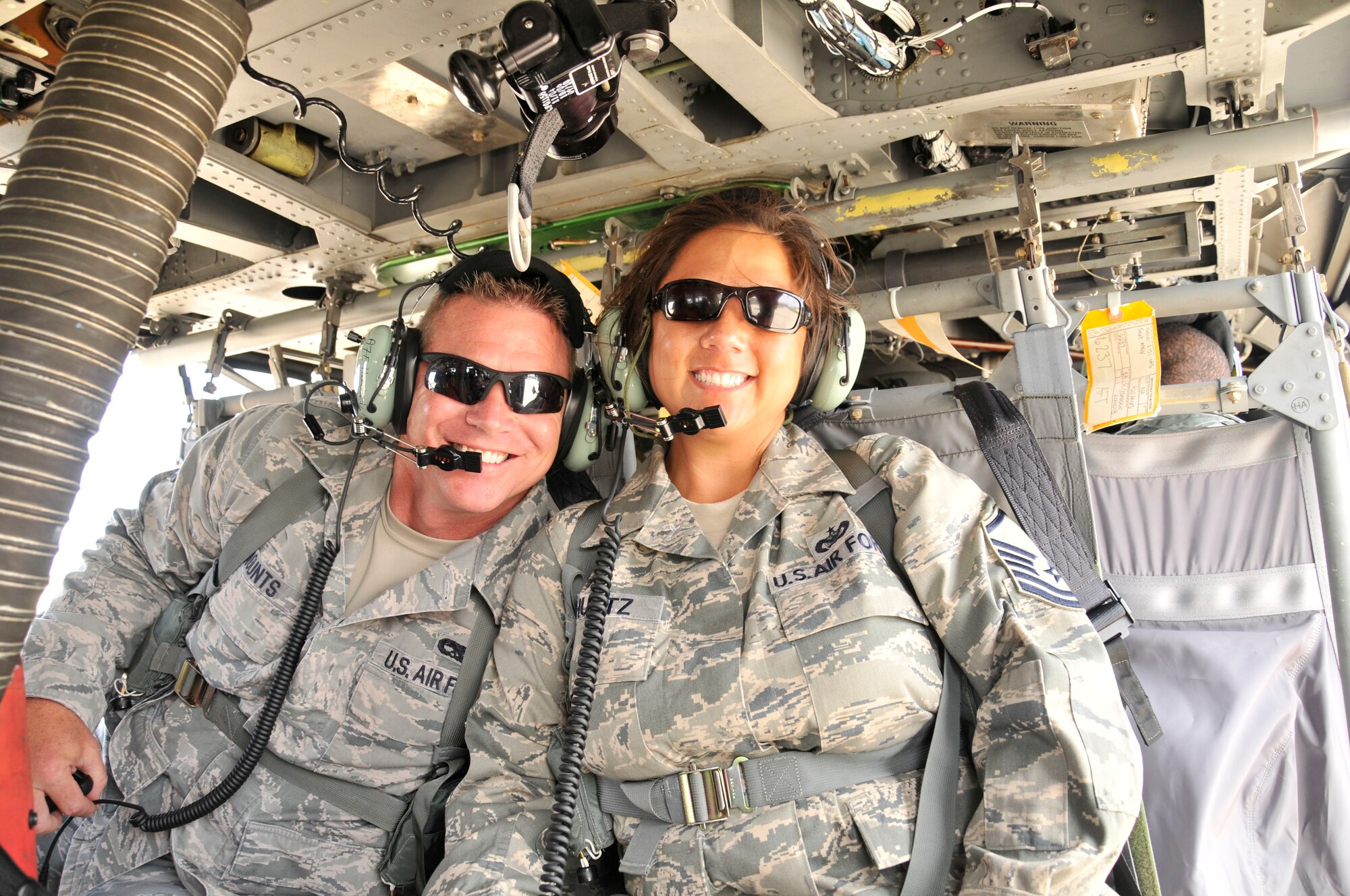 PATRICK AIR FORCR BASE, fla.--Master Sgts. Brian Mounts and Erica Schultz light up with excitement during a local training mission aboard a HH-60G Pave Hawk helicopter that the pair rode along on June 21, here. Already in town for further educational development, Mounts and Schultz along with six other recruiters from different locations along the East Coast were rewarded with a birds-eye view of Cape Canaveral Air Force Station, fla., for being top in their area of expertise. All participating recruiters exceeded recruitment goals in their specific target area. (U.S. Air Force photo/TSgt. Peter Dean)  