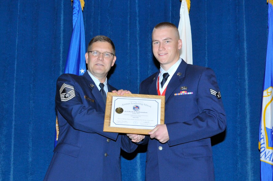 McGHEE TYSON AIR NATIONAL GUARD BASE, Tenn. - Senior Airman Derek Gulbrandson, right, receives the distinguished graduate award for Airman Leadership School Class 12-4 at the I.G. Brown Training and Education Center from Chief Master Sgt. Thomas K. Stoudt, June 7, 2012.  The distinguished graduate award is presented to students in the top ten percent of the class.  It is based on objective and performance evaluations, demonstrated leadership, and performance as a team player. (Air National Guard photo by Master Sgt. Kurt Skoglund/Released)