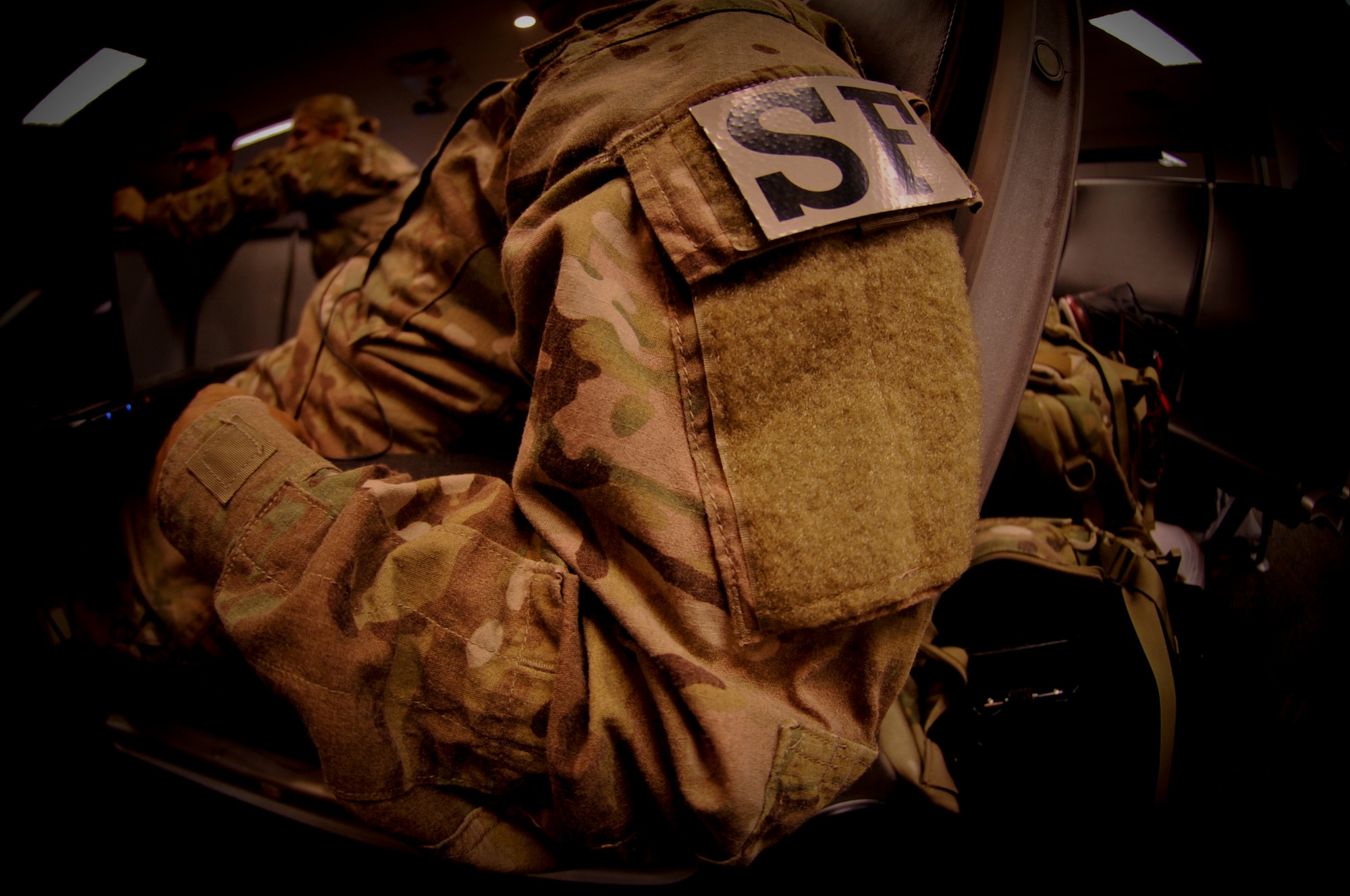 An Airman from the 824th Base Defense Squadron waits in his seat for the word to gather his things and begin his deployment, at Moody Air Force Base, Ga., June 24, 2012. Wearing the new Operation Enduring Freedom Camouflage Pattern will be a first for most of the Airmen deploying with the unit. (U.S. Air Force photo by Senior Airman Nicholas Benroth/Released) 