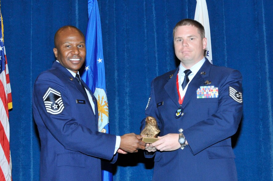 McGHEE TYSON AIR NATIONAL GUARD BASE, Tenn. - Tech. Sgt. Matthew Hivner, right, receives the academic achievement award for NCO Academy Class 12-5 at the I.G. Brown Training and Education Center here from Senior Master Sgt. Tyrone Bingham, left, EPME Director of Education, June 7, 2012.  The academic achievement award denotes excellence as a scholar.  It is based upon all summative objective tests and individual performance evaluations and is given to the student with the highest overall academic standing. (Air National Guard photo by Master Sgt. Kurt Skoglund/Released)