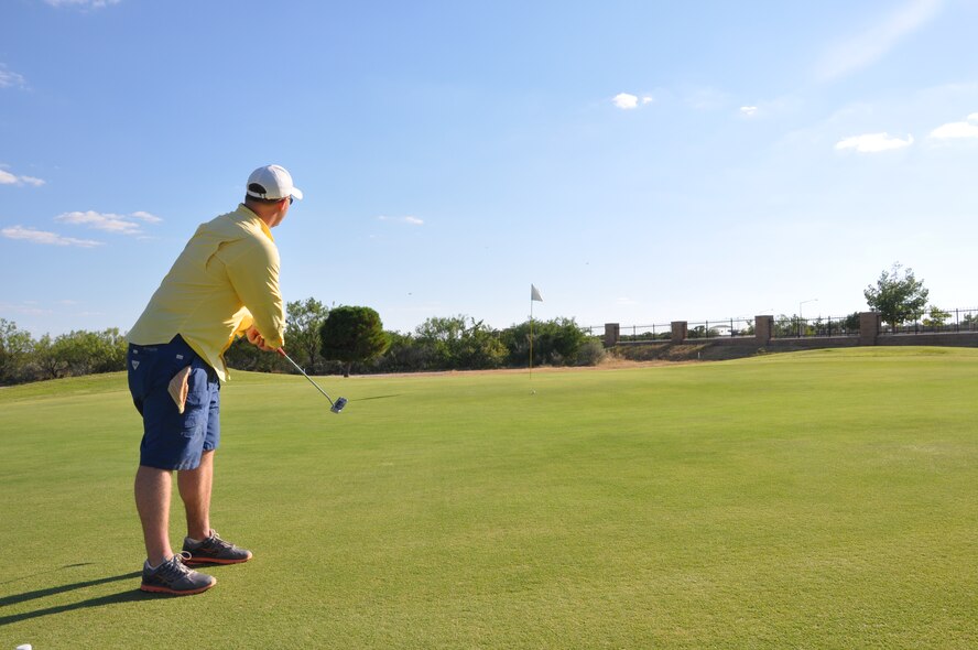 Capt. Ben Sims, 85th Flying Training Squadron, putts at the Leaning Pine Golf Course at Laughlin Air Force Base, Texas, June 24, 2012, during his Hundred Hole Hike. Sims played 108 holes of golf raising more than $4,000 for Operation Proper Exit. (U.S. Air Force photo/2nd Lt. Angela Martin) 