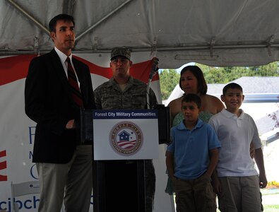 John Ehle, Forest City Communities senior vice president, prepares to hand the keys to a new home to Tech. Sgt. Michael Bradford, 628th Civil Engineer Squadron, his wife Tara and their children, during a ceremony for the ribbon cutting for the newly built privatized housing at Joint Base Charleston- Air Base June 27, 2012.(U.S. Air Force photo/Airman 1st Class Ashlee Galloway)