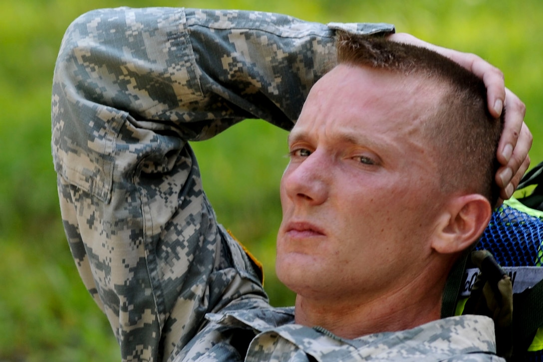 U.S. Army Sgt. 1st Class Adam McQuiston, Fort Leonard Wood, Mo., drill instructor, relaxes for a moment after completing a ruck march from the land navigation course to the confidence course, June 27, 2012, at part of the annual Drill Sergeant of the Year competition, hosted by Initial Military Training, U.S. Army Training and Doctrine Command at Fort Eustis, Va. During the week long competition drill sergeants competed in a variety of events designed to challenge them both physically and mentally. (U.S. Air Force photo by Senior Airman Wesley Farnsworth/Released)
