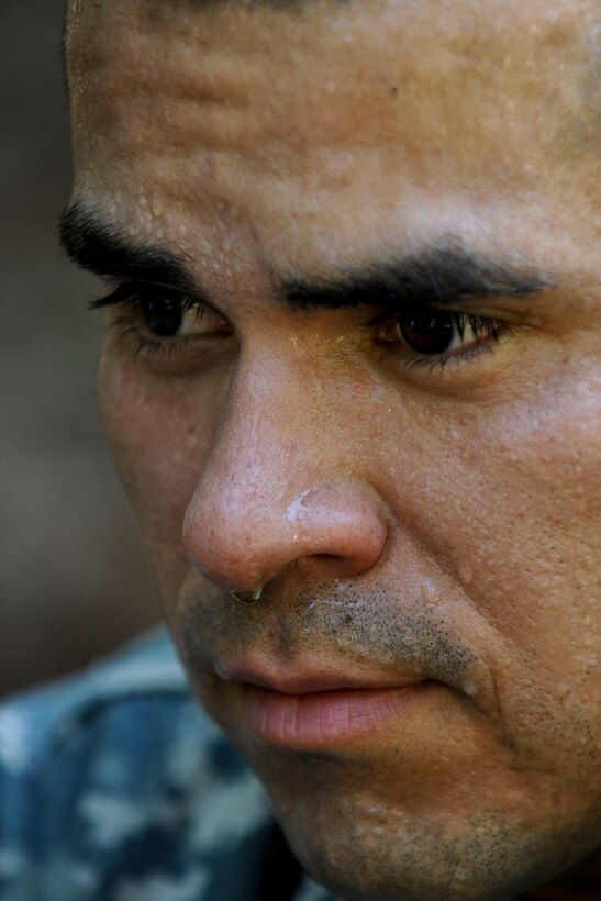 U.S. Army Staff Sgt. Victor Marquez-Rodriguez Sr., Fort Sill, Okla., drill sergeant, sits for a minute with sweat dripping from his face after completing the confidence course, June 27, 2012, at Fort Eustis, Va., as part of the annual Drill Sergeant of the Year competition, hosted by Initial Military Training, U.S. Army Training and Doctrine Command. During the course, competitors had to low crawl, cross monkey bars, climb walls and jump ditches. (U.S. Air Force photo by Senior Airman Wesley Farnsworth/Released)
