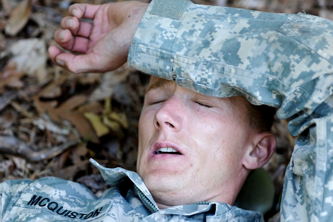 U.S. Army Sgt. 1st Class Adam McQuiston, Fort Leonard Wood, Mo., drill instructor, takes a moment to catch his breath after completing the confidence course, June 27, 2012, at Fort Eustis,Va. Mcquiston and five other Drill Sergeants competed in an annual competition of both mental and physical strength for the title of Drill Sergeant of the Year. (U.S. Air Force photo by Senior Airman Wesley Farnsworth/Released)