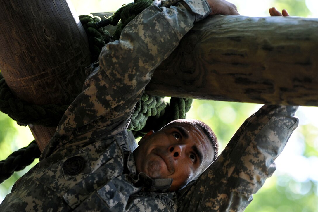 U.S. Army Staff Sgt. Victor Marquez-Rodriguez Sr., Fort Sill, Okla., drill sergeant, climbs across a log to get to a waiting rope that he can use to lower himself down on the confidence course at Fort Eustis, Va., June 27, 2012, as part of the annual Drill Sergeant of the Year competition, hosted by Initial Military Training, U.S. Army Training and Doctrine Command. The yearly competition is designed by the previous year’s winner and is meant to challenge each drill sergeant, both physically and mentally. (U.S. Air Force photo by Senior Airman Wesley Farnsworth/Released)