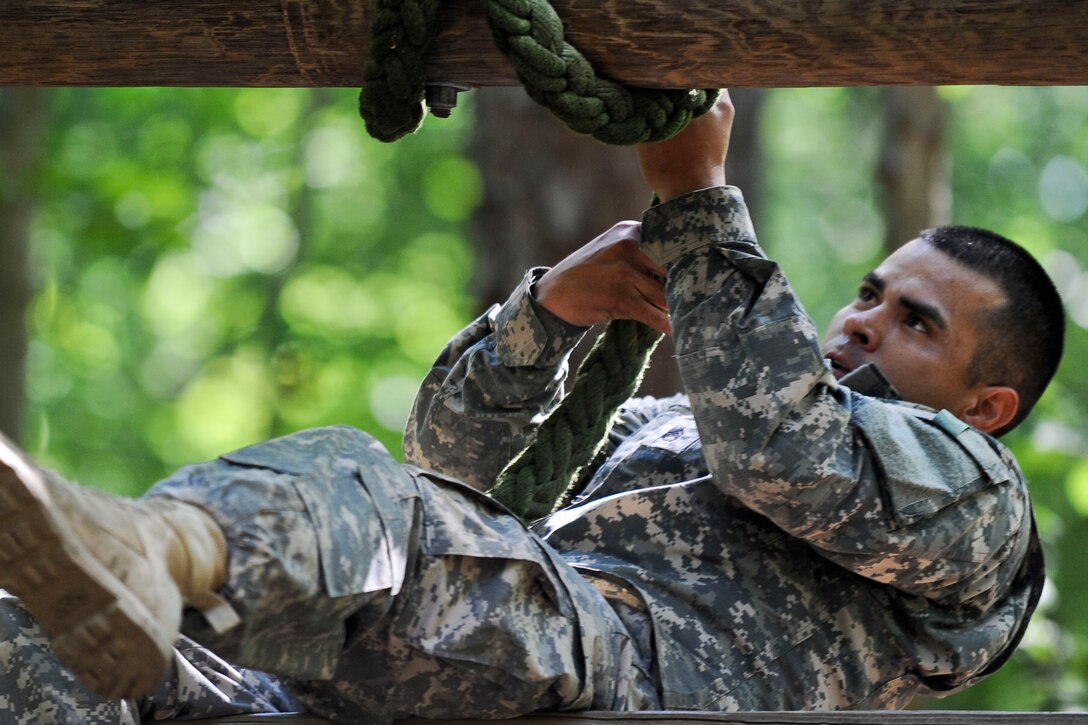 U.S. Army Staff Sgt. Victor Marquez-Rodriguez Sr., Fort Sill, Okla., drill sergeant, pulls himself up a wall using a rope on the confidence course at Fort Eustis, Va., June 27, 2012, as part of the annual Drill Sergeant of the Year competition, hosted by Initial Military Training, U.S. Army Training and Doctrine Command. The yearly competition is designed by the previous year’s winner and is meant to challenge each drill sergeant both physically and mentally. (U.S. Air Force photo by Senior Airman Wesley Farnsworth/Released)
