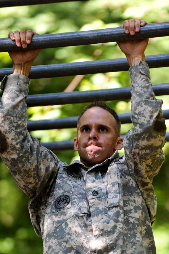 U.S. Army Staff Sgt. Jarod Moss, 95th Reserve Division drill sergeant, completes the final obstacle of the Fort Eustis, Va., confidence course before sprinting to the finish line, June 27, 2012. Moss and four other contestants competed for the fastest time as part of the annual Drill Sergeant of the Year competition, hosted by Initial Military Training, U.S. Army Training and Doctrine Command. (U.S. Air Force photo by Senior Airman Wesley Farnsworth/Released)
