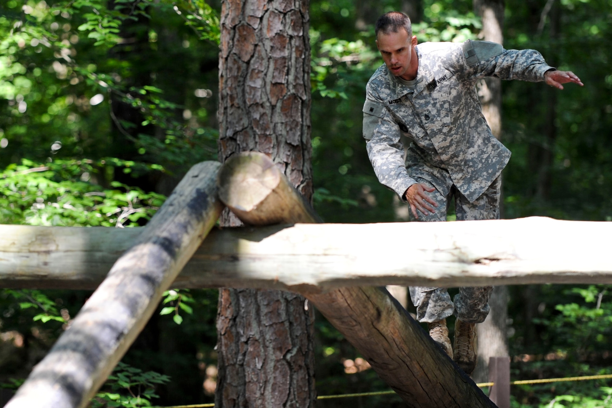 U.S. Army Staff Sgt. Jarod Moss, 95th Reserve Division drill sergeant, navigates an obstacle in the confidence course located at Fort Eustis, Va., June 27, 2012, as part of the annual Drill Sergeant of the Year competition, hosted by Initial Military Training, U.S. Army Training and Doctrine Command. During the course competitors had to do things like; low crawl, cross monkey bars, climb walls and jump ditches.(U.S. Air Force photo by Senior Airman Wesley Farnsworth/Released)