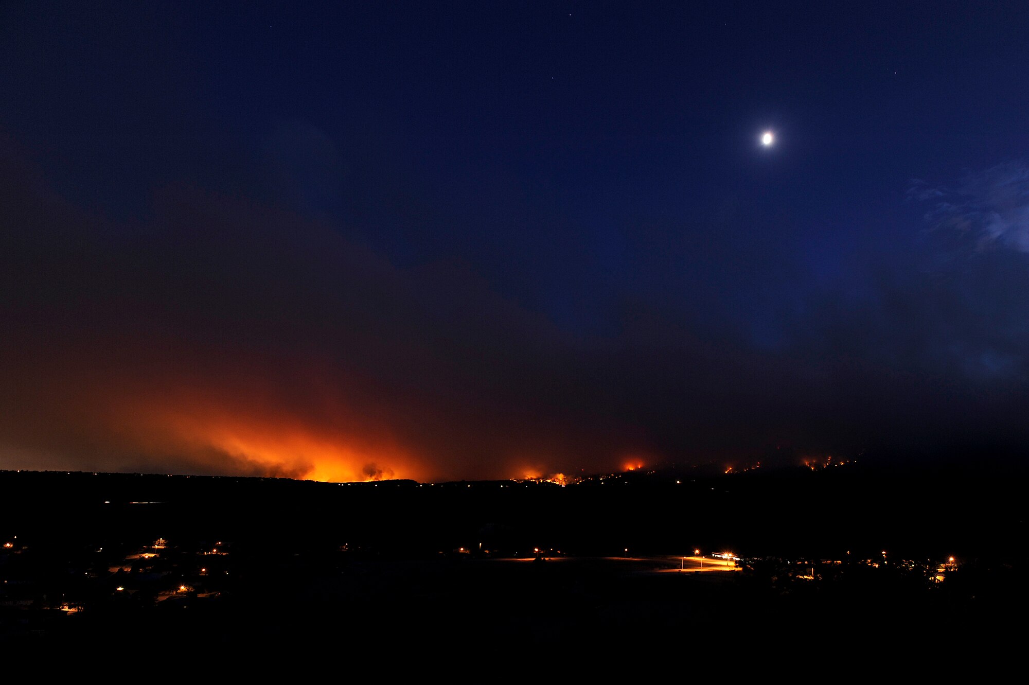 The Waldo Canyon fire burns off the southern border of the U.S. Air Force Academy in Colorado Springs, Colo., June 26, 2012. Mandatory evacuations have been ordered for all housing residents on the Air Force Academy as this fire continues to spread. The Academy's Pine Valley housing area is shown in the foreground.  (U.S. Air Force photo/Mike Kaplan)