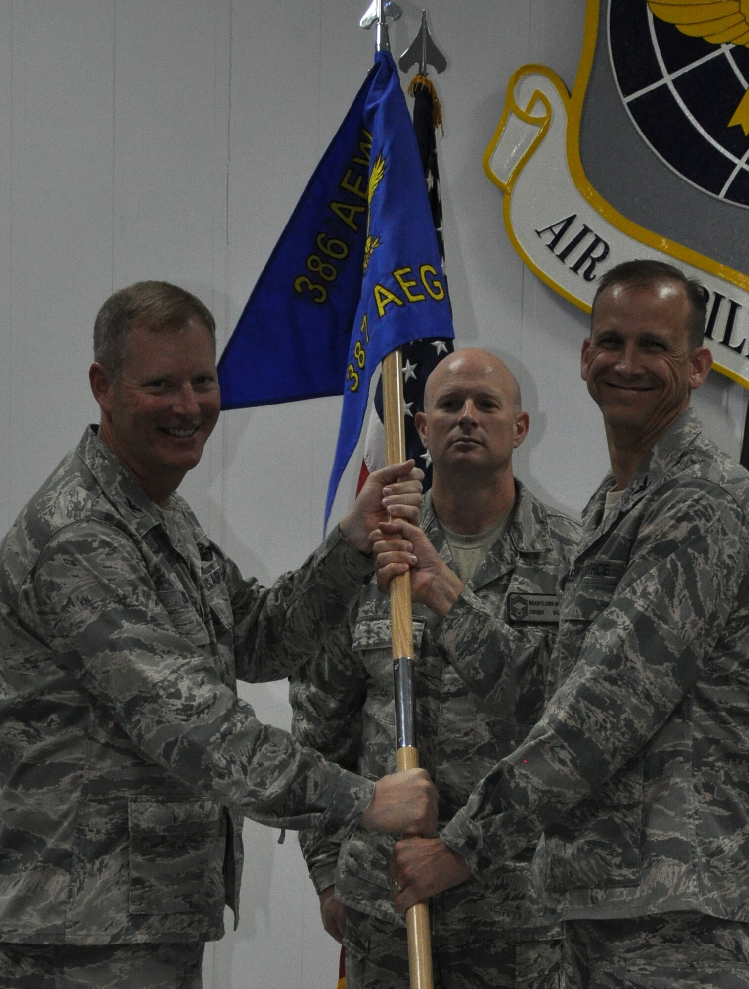 SOUTHWEST ASIA - Col. Michael Zick, 386th Air Expeditionary Wing commander, gives the 387th Air Expeditionary Group guidon to Col. Charles Schlagel, during the change of command ceremony here June 27, 2012. (U.S. Air Force photo/Master Sgt. Kristina Barrett)