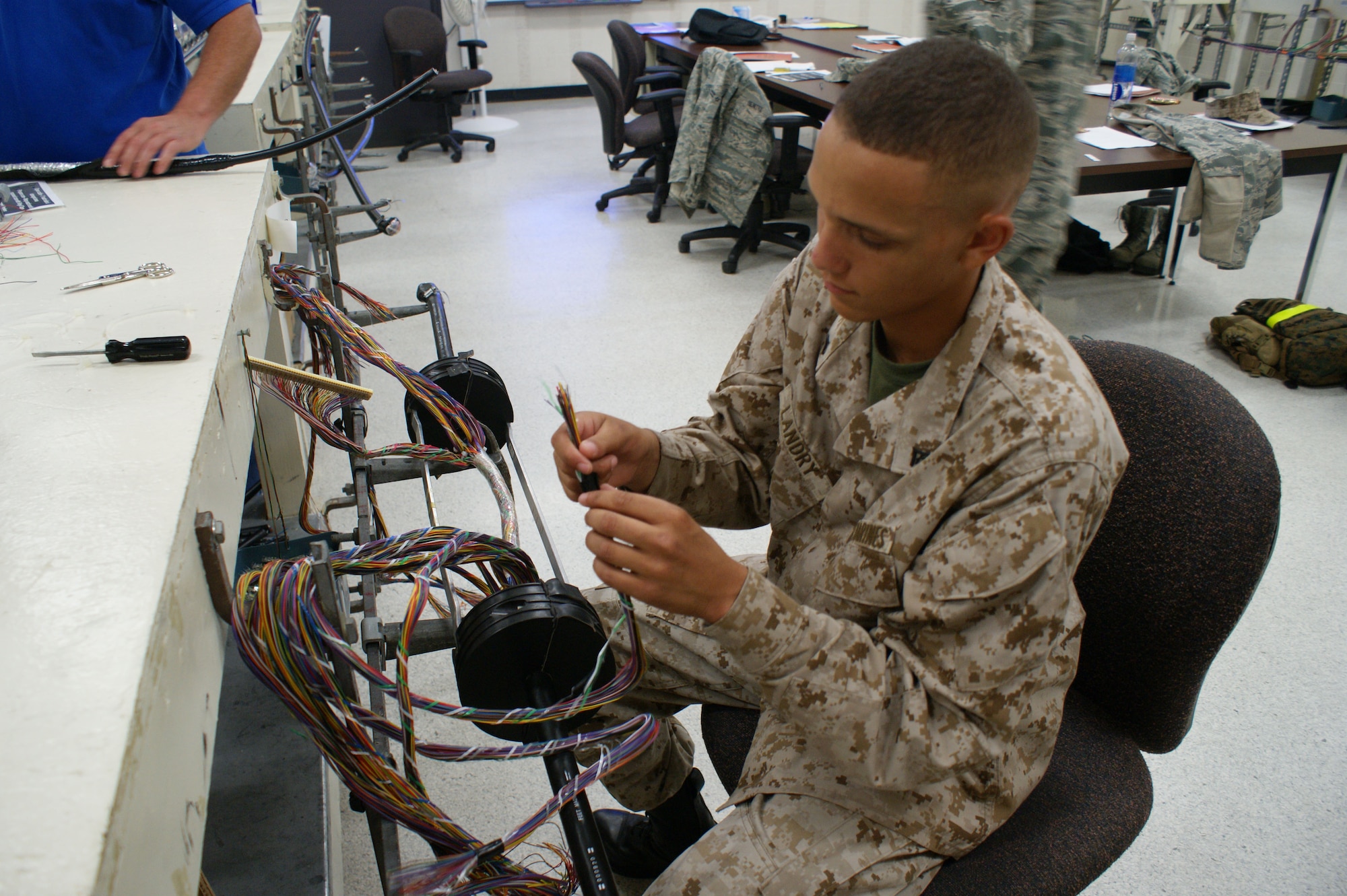 Lance Cpl. Jordan Landry, USMC, inspects antenna cable during the Communications Cable and Antenna Systems apprentice course Jun 26, 2012 at Sheppard Air Force Base, Texas.   The United States Marines Corps graduates approximately 60 students annually from the course, along with approximately 290 students from the Air Force and Army.  (U.S. Air Force photo/Dan Hawkins)