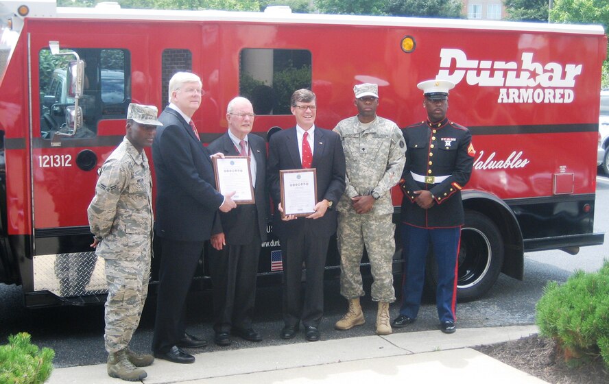 (L-R), Airman 1st Class Brandon Wilson, Maryland Air National Guard, George Doetsch, Md. ESGR State Chairman, James Dunbar, Sr., Chairman/Founder of Dunbar Armored, Kevin Dunbar, President/CEO Dunbar Armored, Spc. Dexter Johnson, U.S. Army Reserve, Cpl. Najee Corbett, U.S. Marine Corps Reserve stand in front of a Dunbar Armored vehicle after signing a statement of support with the Employer Support of the Guard and Reserve. ESGR is a Department of Defense agency whose mission is to promote a culture in which all American employers support and value their military employees. ESGR educates the employers about their employee’s rights who leave their civilian employment to perform their military training whether it is drill weekends, annual training, schooling or deployments. The statement of support is to reinforce to the employer that they are taking care of their employees. (Courtesy Photo)