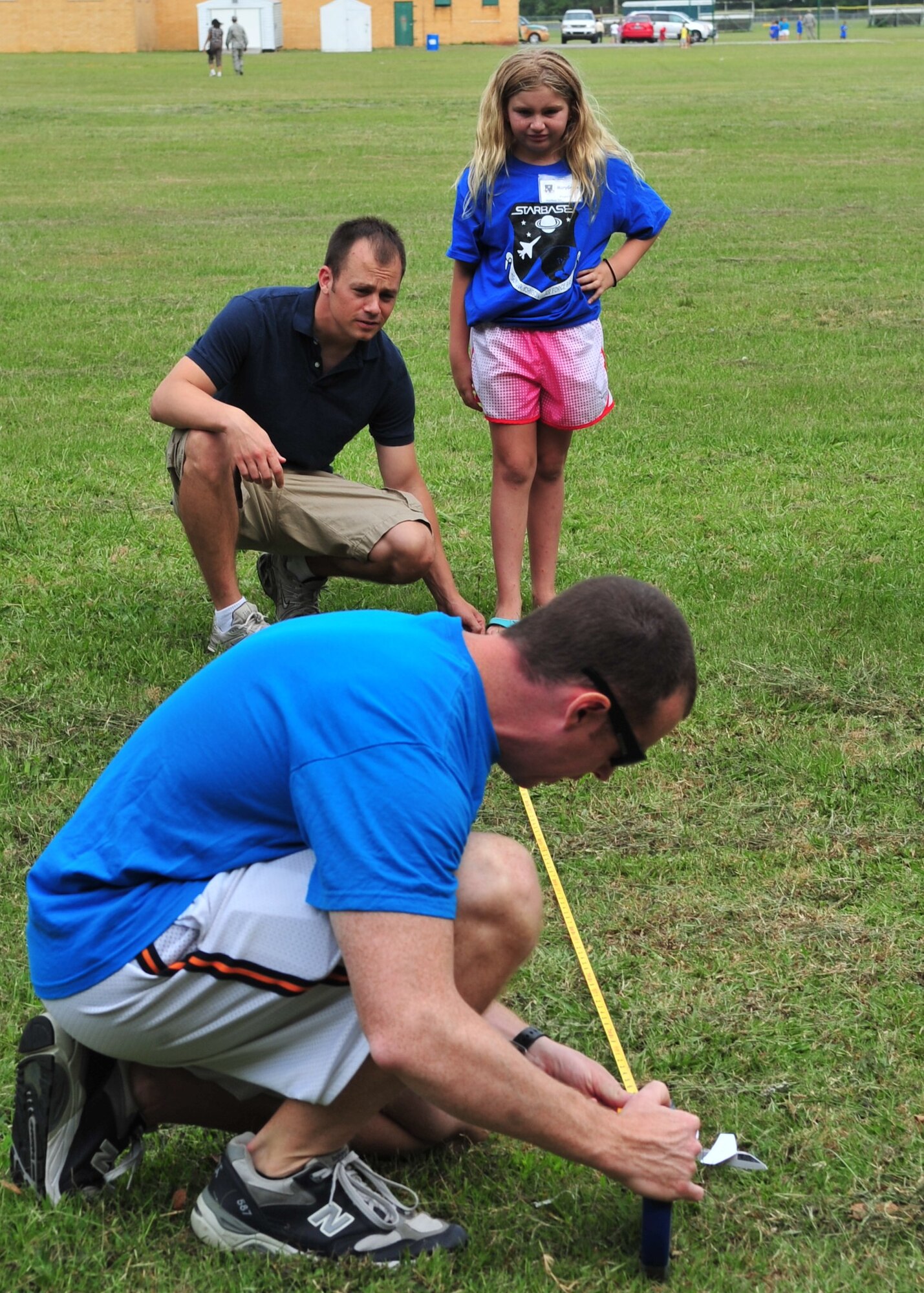 U.S. Air Force Maj. Chris Crotty with the assistance of Capt. Drew Bures measures how far MaryGrace Wiggin’s paper airplane flew during the final day of the Science and Technology Academies Reinforcing Basic Aviation and Space Exploration Program at Greenwood Middle School in Goldsboro, N.C., June 22, 2012. MaryGrace is the daughter of Mary and Ken Wiggins, residents of Goldsboro. Crotty is the 4th Fighter Wing military STARBASE representative and 4th Training Squadron instructor division chief. Bures is a 333rd Fighter Squadron instructor pilot. (U.S. Air Force photo/Tech. Sgt. Tammie Moore/Released)