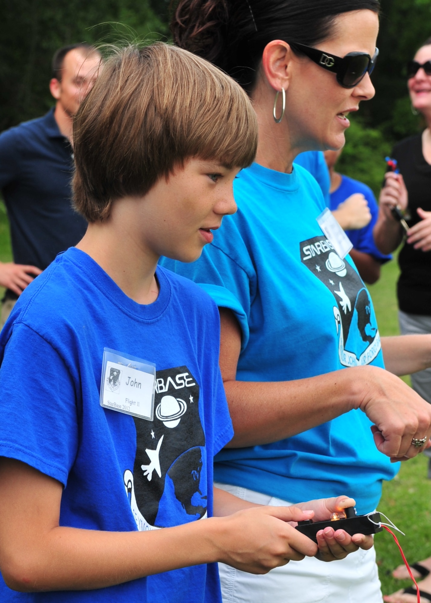 John Davis, 10, prepares to push the button that will launch his rocket as Tanya Grady counts down to launch during the final day of the Science and Technology Academies Reinforcing Basic Aviation and Space Exploration Program at Greenwood Middle School in Goldsboro, N.C., June 22, 2012. Through STARBASE, upcoming fifth graders visit the base each day to learn about topics ranging from compass reading to tools used for weather prediction and will witness the laws of motion in action. John is the son of JoAnn and Lee Davis, residents of Goldsboro. Grady is a STARBASE instructor. (U.S. Air Force photo/Tech. Sgt. Tammie Moore/Released)