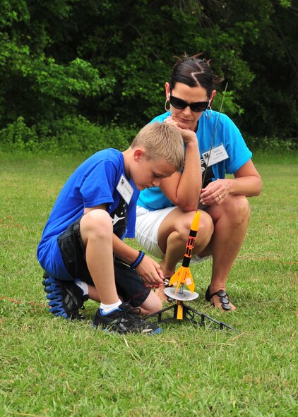Strother Brown, 10, prepares his rocket as Tanya Grady observes during the final day of the Science and Technology Academies Reinforcing Basic Aviation and Space Exploration Program at Greenwood Middle School in Goldsboro, N.C., June 22, 2012. Through STARBASE, risinging fifth graders visit Seymour Johnson Air Force Base each day to learn about topics ranging from compass reading to tools used for weather prediction and will witness the laws of motion in action. Strother is the son of U.S. Air Force Senior Master Sgt. Strother Brown, 4th Equipment Maintenance Squadron armament flight chief. Grady is a STARBASE instructor. (U.S. Air Force photo/Tech. Sgt. Tammie Moore/Released) 