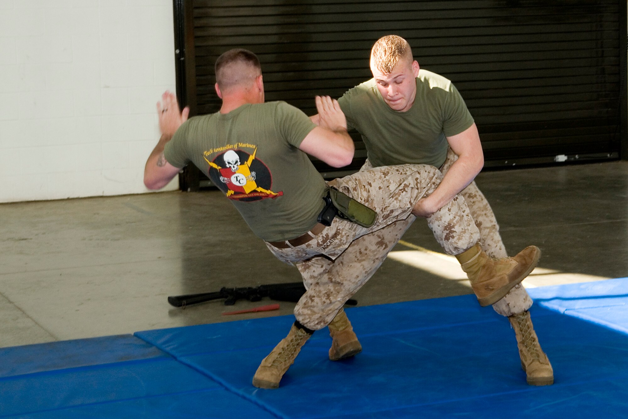 GRISSOM AIR RESERVE BASE, Ind. -- Lance Cpl. Darin Ratliff, a data technician, takes down Sgt. Daniel Accatino, a training chief, during a martial arts demonstration for junior ROTC students visiting the Marine Corps Reserve Center at Grissom May 23. Both Marines are with Detachment 1, Communications Company, Headquarters and Service Battalion, 4th Marine Logistics Group.
