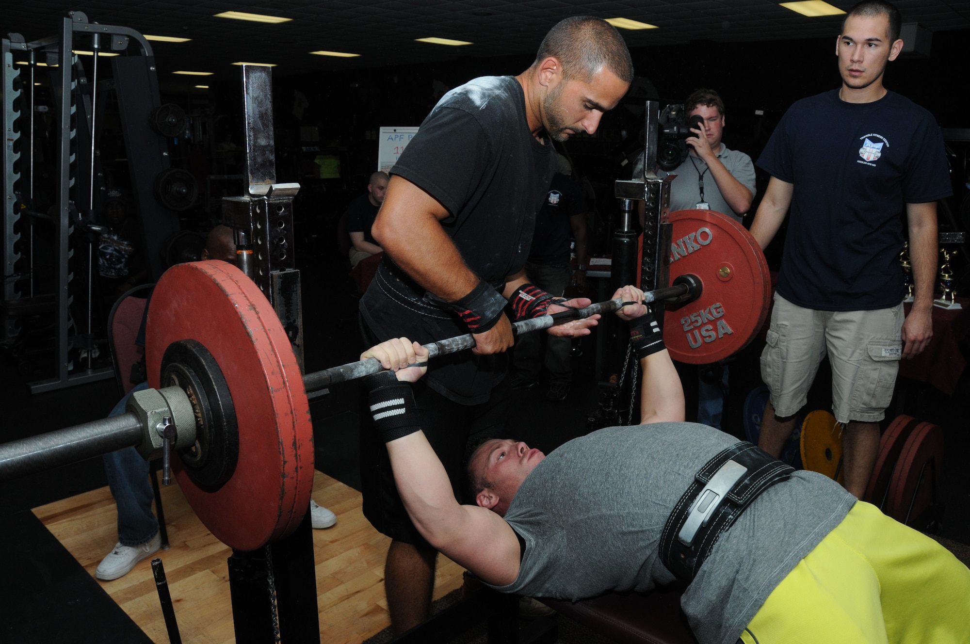 Justin Trott, spouse of 2nd Lt. Charlotte Trott, 81st Inpatient Operation Squadron, spots Staff Sgt. Austin Sutton, 81st Security Forces Squadron, in the bench press category at the American Powerlifting Federation event at the Triangle Fitness Center June 22, 2012, Keesler Air Force Base, Miss.  Fifteen participants completed squats, bench presses and dead lifts in four categories — open raw division, equipped division, masters division and women division.  Sutton placed 1st in the male open/raw division.  (U.S. Air Force photo by Kemberly Groue)