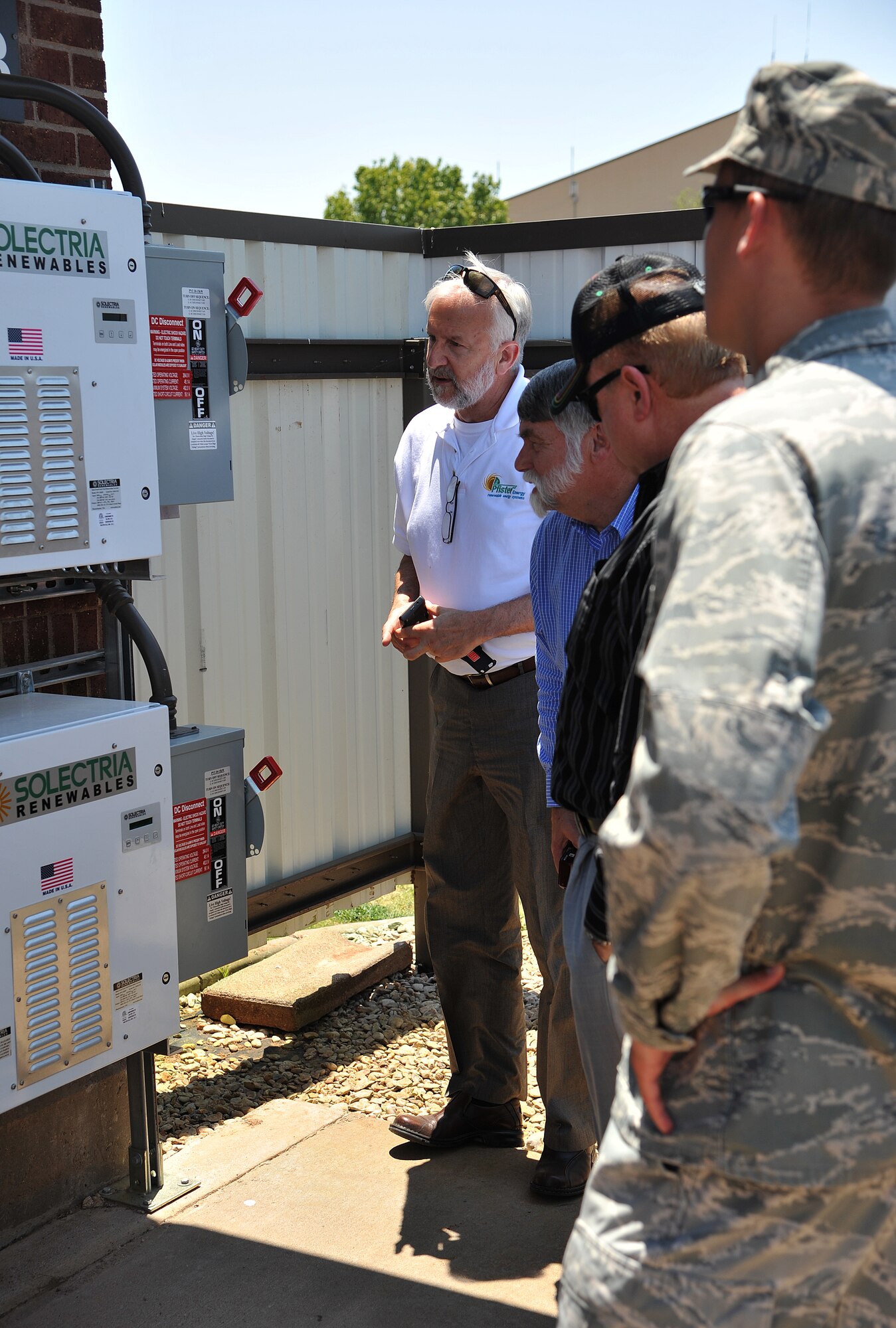 GOODFELLOW AIR FORCE BASE, Texas-- William Poleatewich, Director of Technologies at Pfister Energy, gives an on-site tour of the new 17th Security Forces Squadron High-Performance Energy-Efficient Cool Metal Roof and its essential parts June 27. The new roof produces solar energy to the building and also helps to collect rain water. (U.S. Air Force photo/Airman 1st Class Michael Smith) 