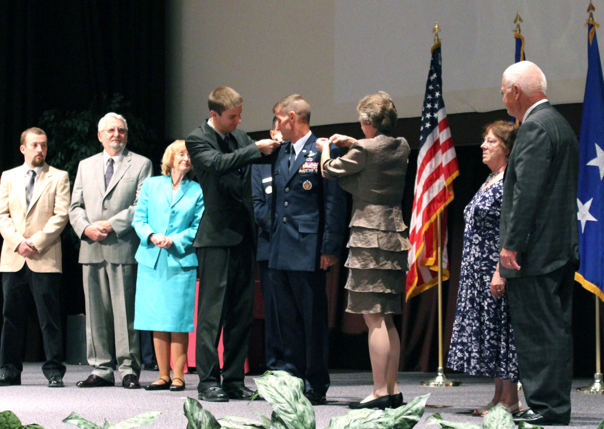 MAXWELL AIR FORCE BASE-GUNTER ANNEX, Ala. - Maj. Gen. Craig Olson gets his second star pinned on by his wife, Dayna, and son, Matthew, during his promotion ceremony at the Senior NCO Academy Auditorium June 25, while other family members look on. Olson is currently the Business and Enterprise Systems program executive officer but has been selected by the Air Force to become the PEO for C3I and Networks. (U.S. Air Force photo by Robert Paschen)