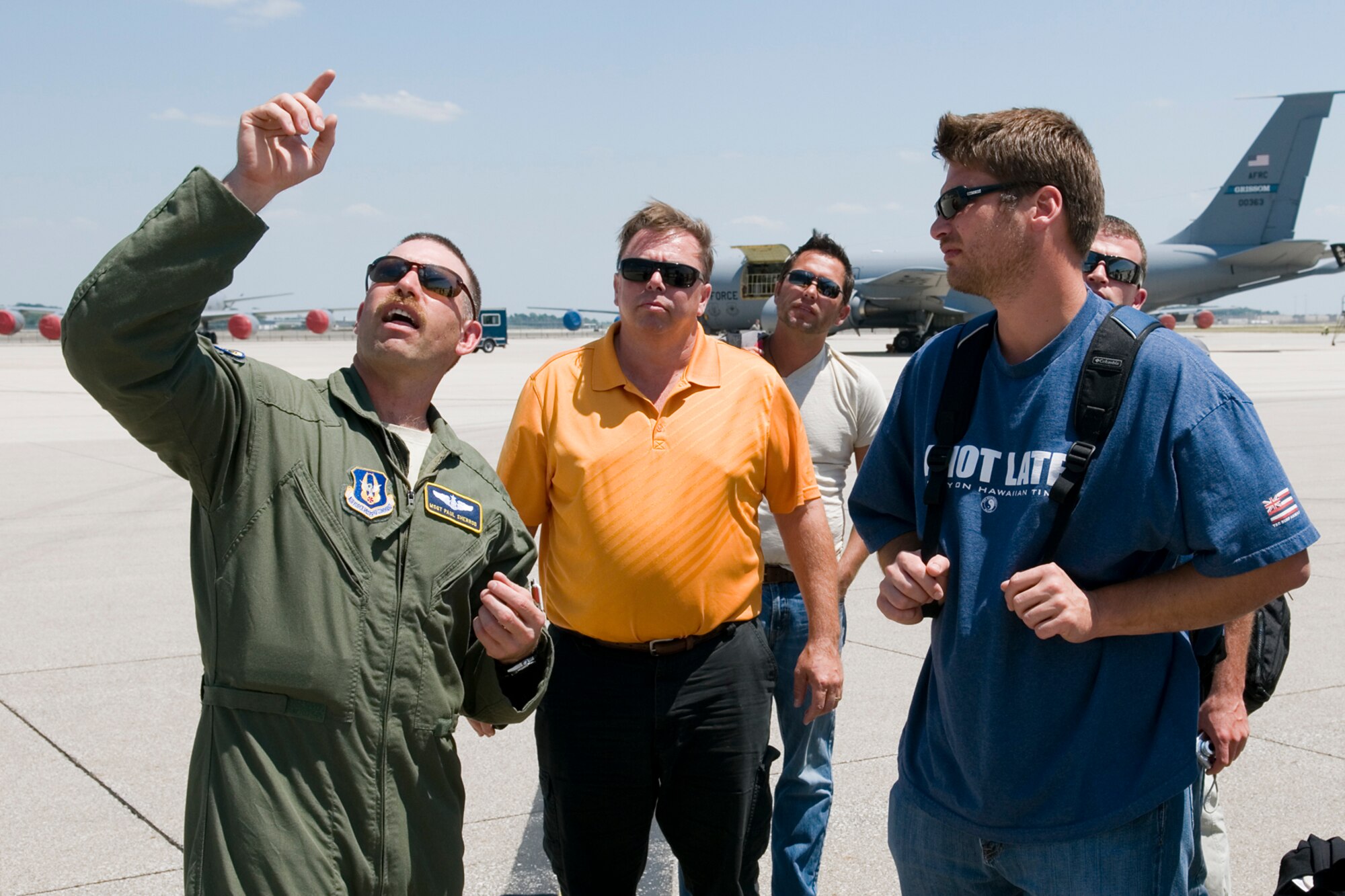 GRISSOM AIR RESERVE BASE, Ind. -- Master Sgt. Paul Sherrod, 434th Air Refueling Wing boom operator, speaks with passengers after their flight aboard a KC-135R Stratotanker June 20. Grissom honorary commanders and local civic leaders visited the base and flew during an in-flight refueling to learn about the mission of the 434th ARW. (U.S. Air Force photo/Senior Airman Andrew McLaughlin)  