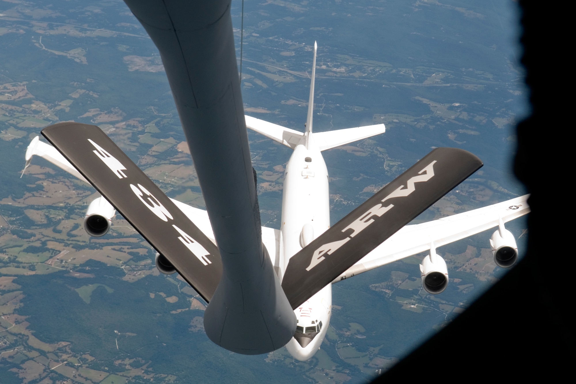 GRISSOM AIR RESERVE BASE, Ind. -- A Navy E-6B Mercury from Tinker Air Force Base, Okla., pulls away from a KC-135R Stratotanker with the 434th Air Refueling Wing after completing an aerial refueling June 20. Grissom honorary commanders and local civic leaders flew aboard the KC-135R to learn about the mission of the 434th ARW. (U.S. Air Force photo/Senior Airman Andrew McLaughlin)
