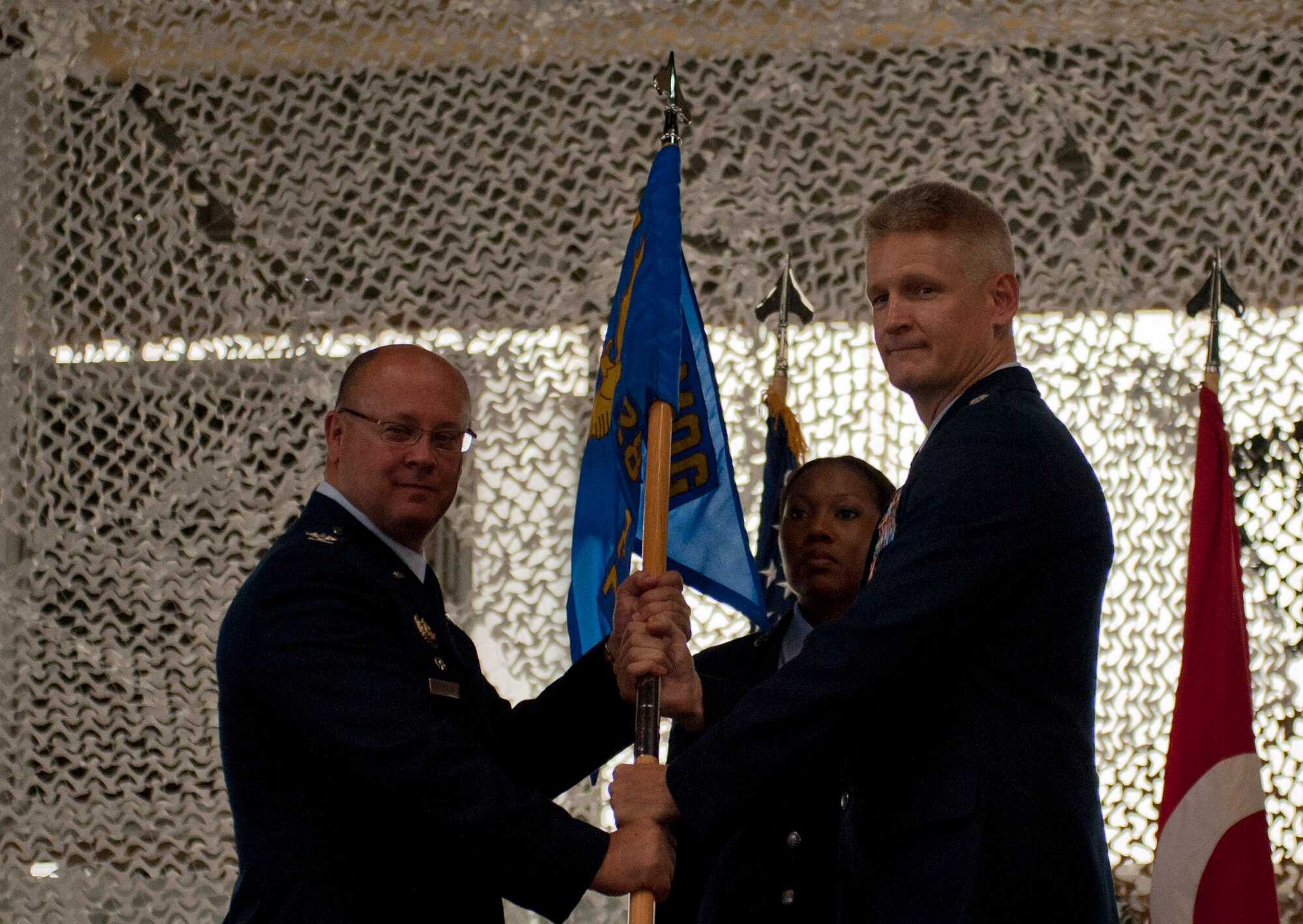 Lt. Col. Brian Lindsey, outgoing 728th Air Mobility Squadron commander, relinquishes command of the 728th AMS to Col. James Regenor, 521st Air Mobility Group commander, during the change-of-command ceremony June 27, 2012 at Incirlik Air Base, Turkey. Lindsey will be replaced by Lt. Col. Henry Triplett III. (U.S. Air Force photo by Senior Airman Anthony Sanchelli/Released) 
