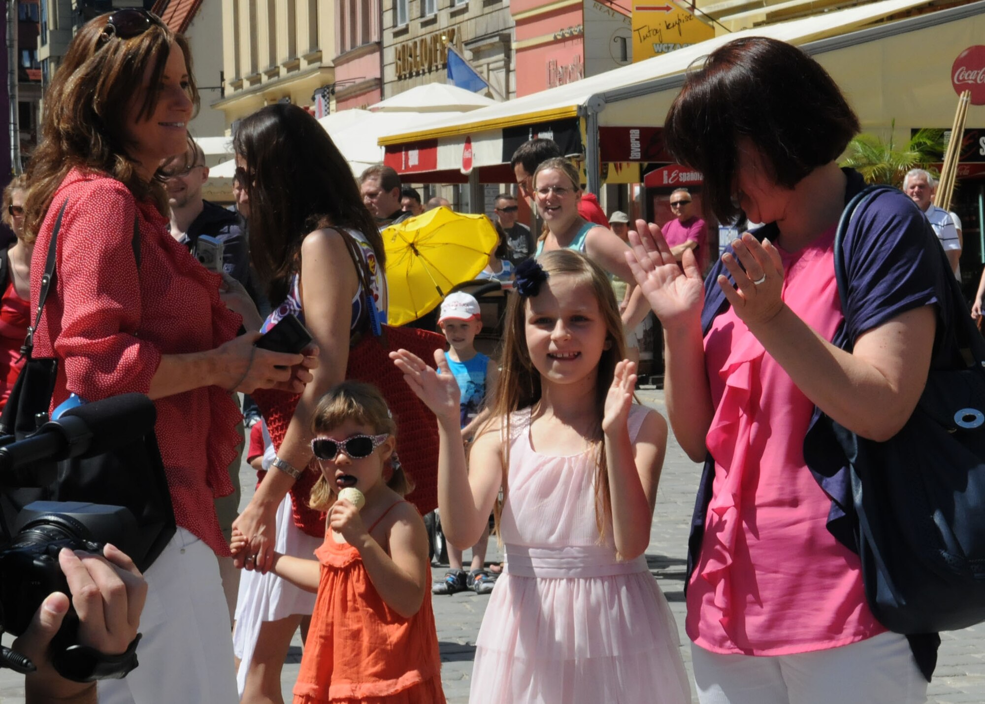 Onlookers applaud as the U.S. Air Forces in Europe Band passes during a parade June 23, 2012, in Wroclaw, Poland. The parade concluded at the United European Football Association fanzone in Wroclaw, where the band performed for onlookers. The USAFE band visited Wroclaw to participate in the International Air Force Bands Festival hosted by Lt. Gen. Lech Majewski, Polish Air Force commander. (U.S. Air Force photo by Senior Airman Marissa Tucker/Released)