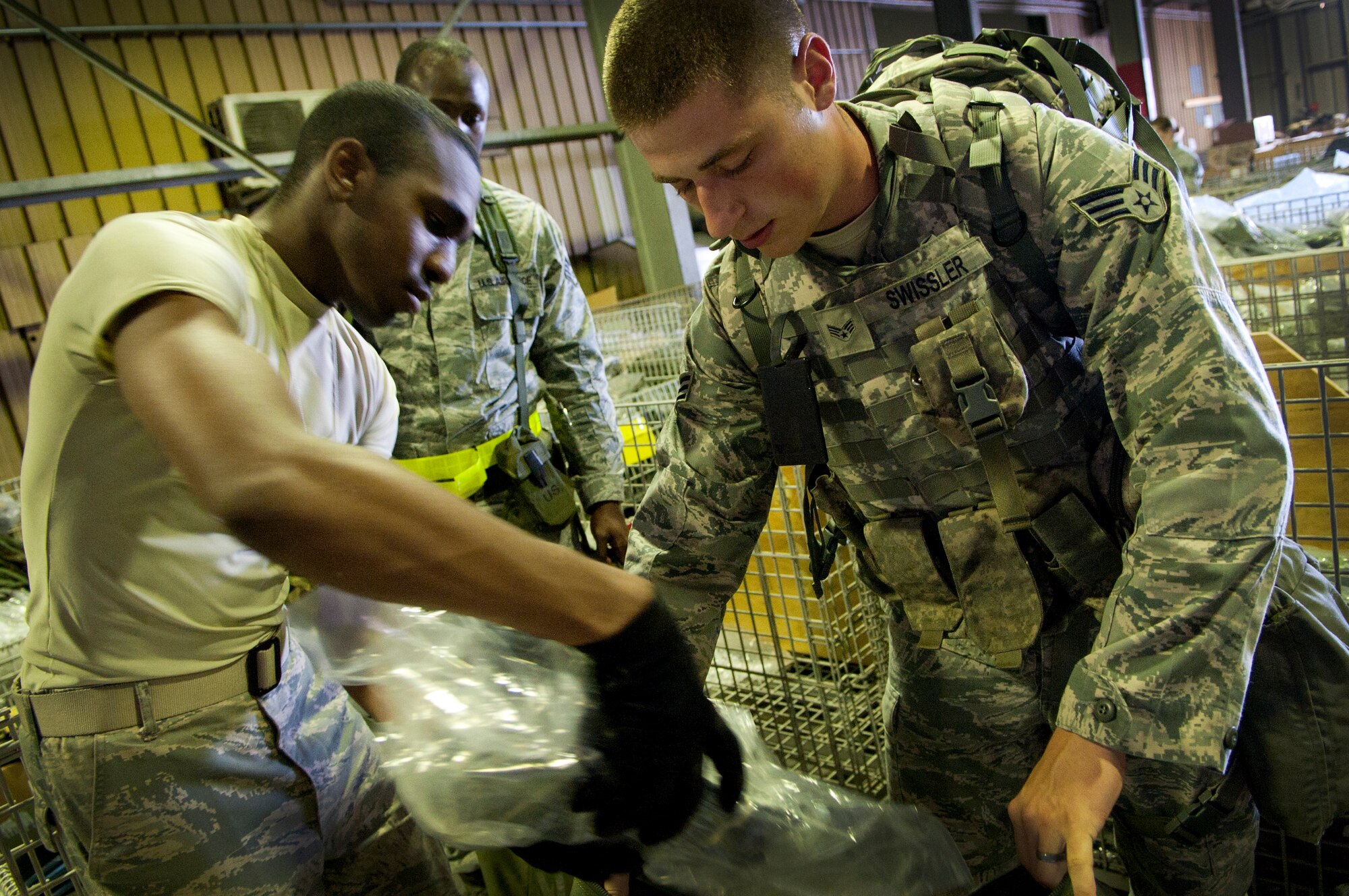 Senior Airman Jared D. Swissler 31st Security Forces Squadron entry controller, assembles individual protective equipment in preparation for a simulated deployment as part of a local readiness exercise at Aviano Air Base June 18. During the LRE, members were evaluated on their ability to deploy in support of contingencies at a moment’s notice. (U.S. Air Force photo/Staff Sgt. Evelyn Chavez)
