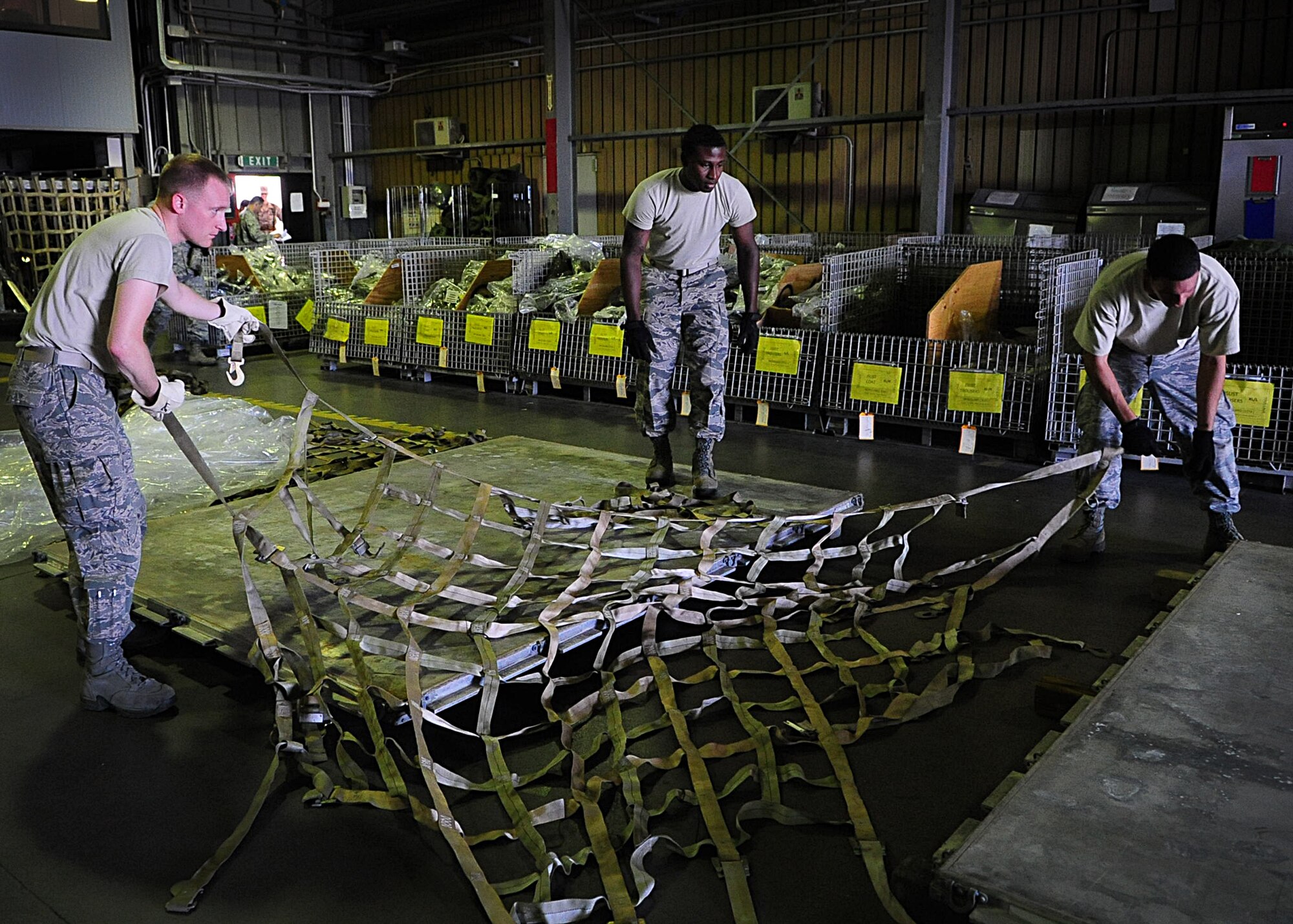 Members of the 31st Logistics Readiness Squadron prepare a pallet to load deployers’ mobility bags in support of a simulated contingency. The exercise helped provide on-the-job training for 31st LRS members as well as, helping them gauge their ability to process deploying members for short notice taskings. (U.S. Air Force photo/Staff Sgt. Evelyn Chavez)