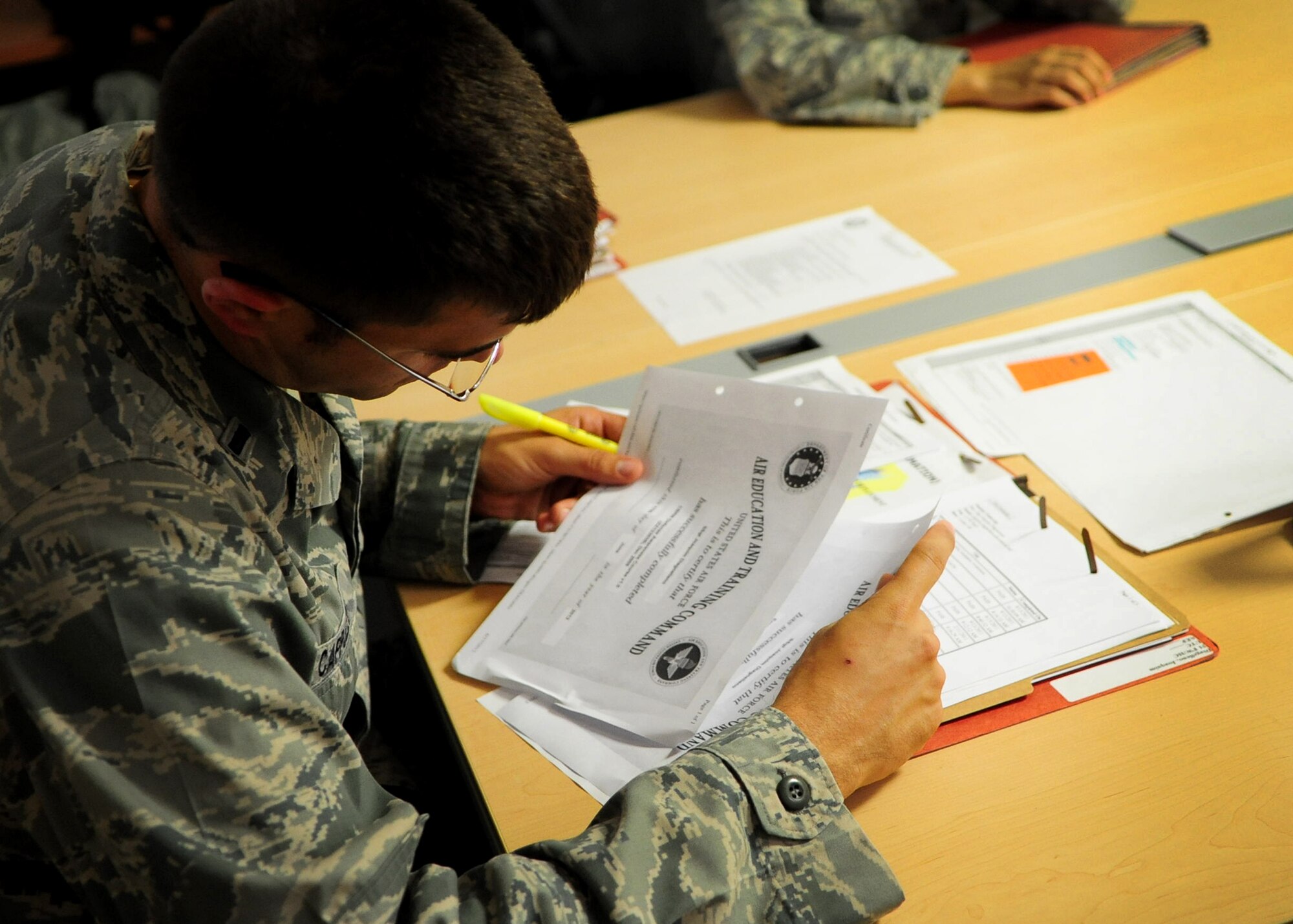 In preparation for a simulated deployment as part of a local readiness exercise, 1st Lt. Gregory D. Cappuzzo, 31st Comptroller Squadron, reviews a fellow squadron member’s mobility folder at Aviano Air Base June 18. Servicemembers currently in their air and space expeditionary force band are required to ensure they have up-to-date records and training to support contingencies at a moment’s notice. (U.S. Air Force photo/Staff Sgt. Evelyn Chavez)