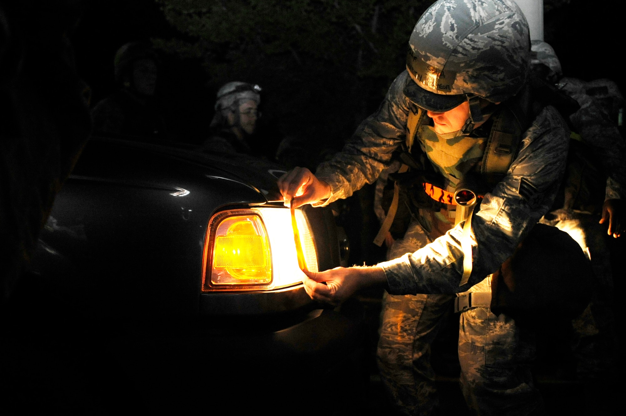 Senior Airman Jeremy Robinson, 8th Civil Engineer Squadron water and fuels, demonstrates blackout procedures during PRIME Beef training June 21, 2012, at Kunsan Air Base, Republic of Korea. The CES conducted the training to hone the way they conduct nighttime contingency operations. (U.S. Air Force photo/Senior Airman Brigitte N. Brantley)