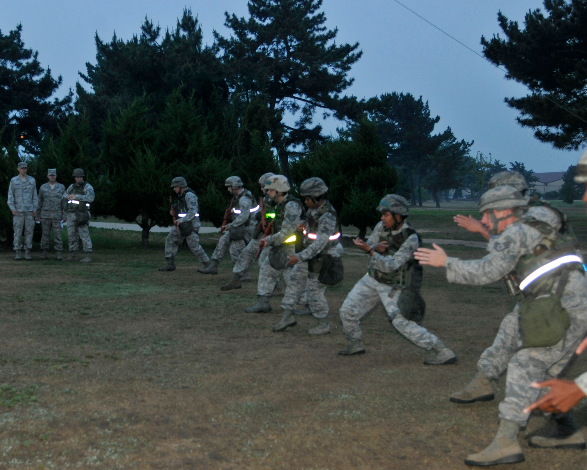 Airmen from the 8th Civil Engineer Squadron move silently during night contingency operations at Kunsan Air Base, Republic of Korea, June 21, 2012. The Airmen took turns practicing the ghost walk, cat walk, kitten crawl, low crawl and the roll techniques. (U.S. Air Force photo/Senior Airman Marcus Morris)