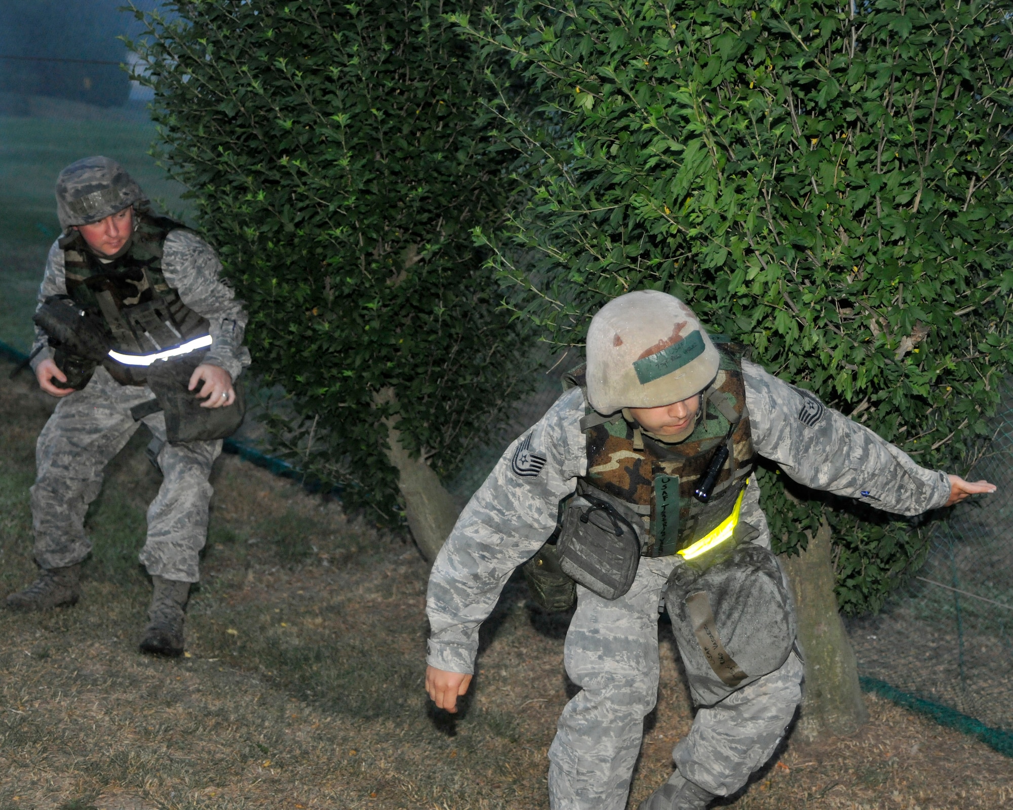 Staff Sgt. Jerry Bonds, left, 8th Civil Engineer Squadron service contracts, and Tech. Sgt. Rigoberto Vasquez, 8th CES NCO in charge of service contracts, use the defense concealment training they received that morning to get to the assigned check-point at Kunsan Air Base, Republic of Korea June 21, 2012. The objective of this exercise was to use the terrain and darkness to move without being seen by the enemy. (U.S. Air Force photo/Senior Airman Marcus Morris)