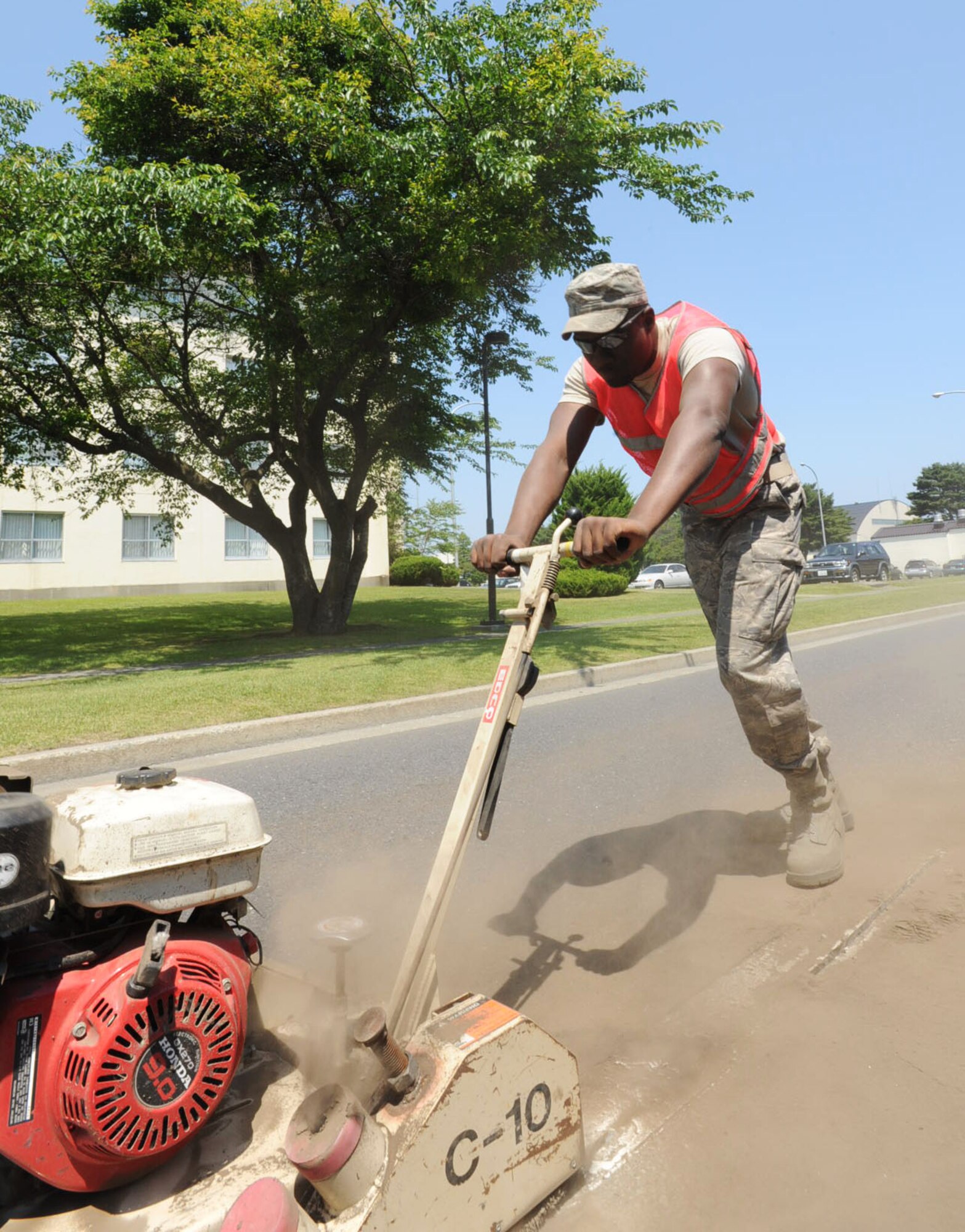 U.S. Air Force Senior Airman Daniel Perry, 35th Civil Engineer Squadron pavement and construction shop member, operates an air compressor bit to repair cracks on Freedom Drive at Misawa Air Base, Japan, June 27, 2012. After expanding the cracks in the road, the air compressor bit is used to clean out the debris and prepare cracks to be filled with hot asphalt sealant. (U.S. Air Force photo by Airman 1st Class Kenna Jackson/Released)