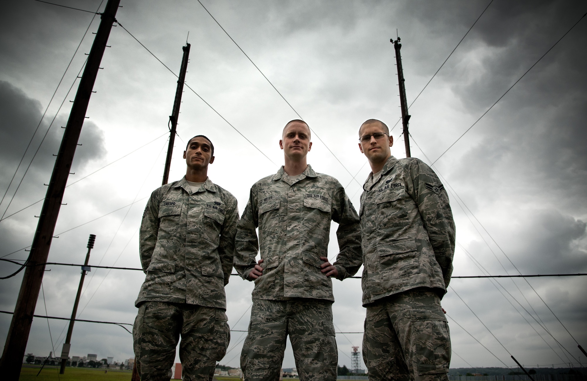 YOKOTA AIR BASE, Japan -- From the left, Airman 1st Class Leonel Crespo, Staff Sgt. Robert Miller, and Airman 1st Class Lucas Dugan, 374th Communications Squadron airfield systems technicians, stand together near the airfield systems building at Yokota Air Base, Japan, June 25, 2012. Anyone who lands an airplane at Yokota owes their lives to these three Airmen, part of the 374th CS airfield systems flight. They are responsible for making sure aircraft can find and land on Yokota's runways, even in the worst weather conditions. (U.S. Air Force photo by Staff Sgt. Shawn Rhodes)