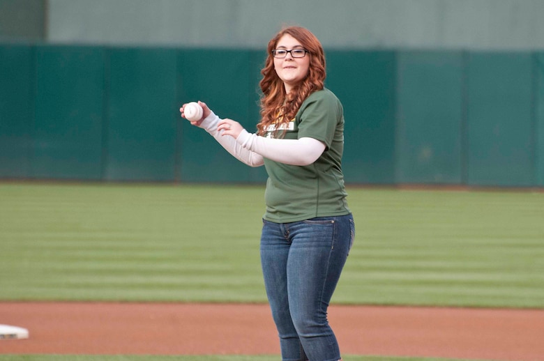 OAKLAND, Calif. — Allie Pearce throws out the ceremonial first pitch on her 16th birthday before the Oakland Athletics game against the San Francisco Giants at O.co Coliseum here, June 22, 2012.